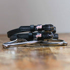ManeJane Pink Dinosaur Spur Straps Spur Straps — black leather, non-stretch, hero image for English riders.
