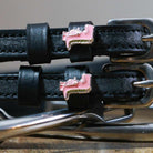 Pink Dinosaur Spur Straps black leather with pink dinosaur charm and stainless steel buckle