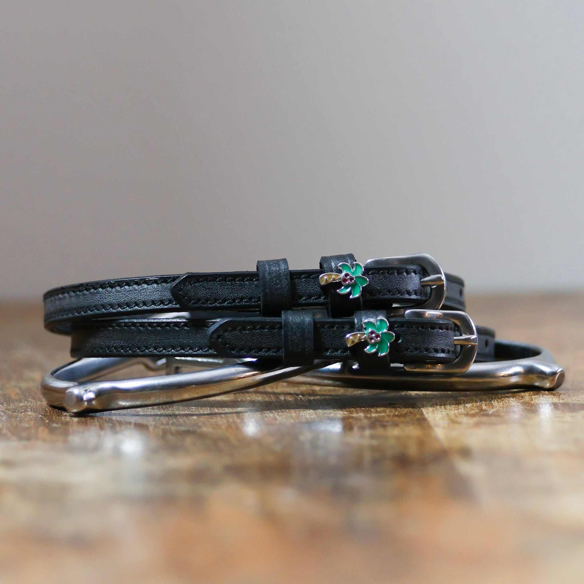 ManeJane Palm Tree Spur Straps Spur Straps — black leather, non-stretch, hero image for English riders.
