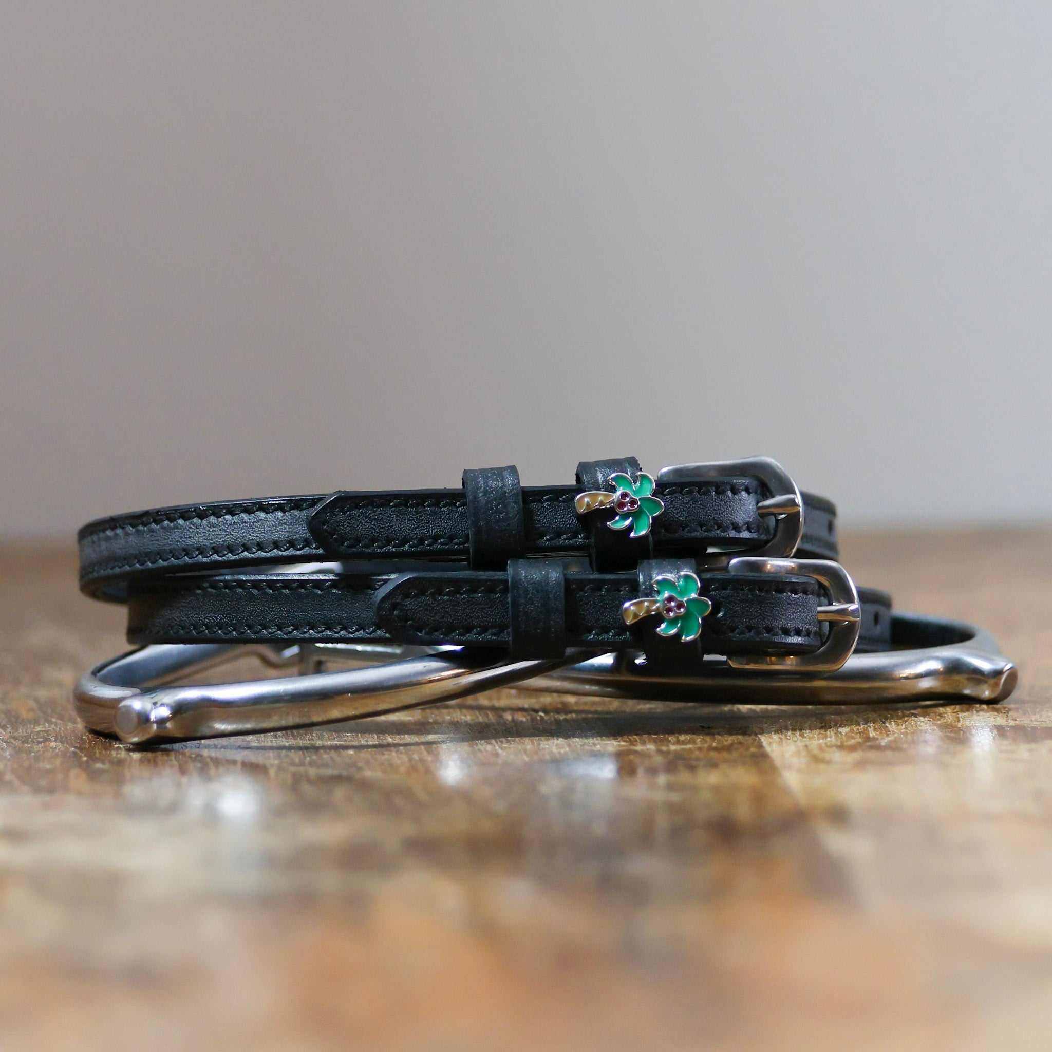 ManeJane Palm Tree Spur Straps Spur Straps — black leather, non-stretch, hero image for English riders.