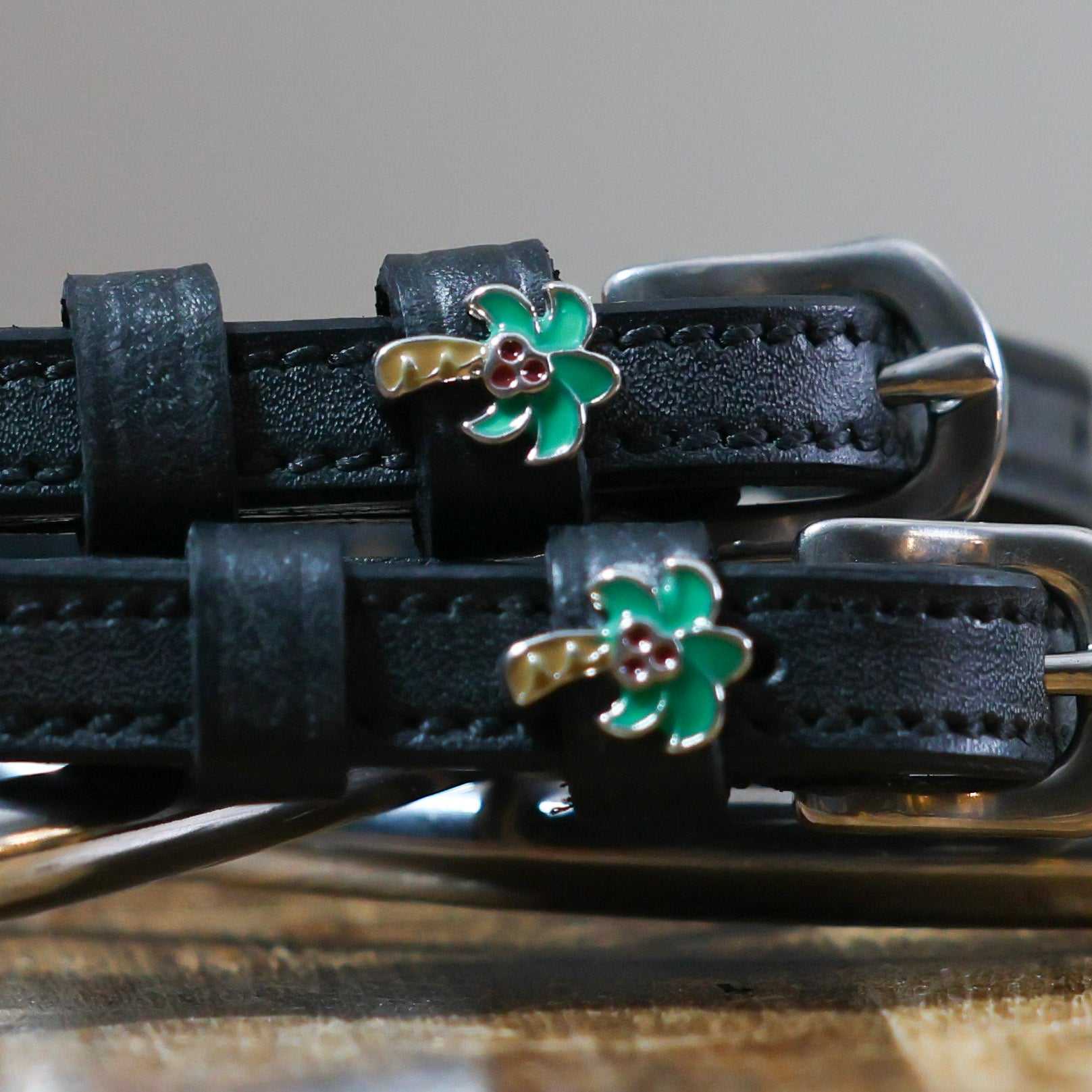 Black leather Palm Tree Spur Straps with green palm tree charm and stainless steel buckles