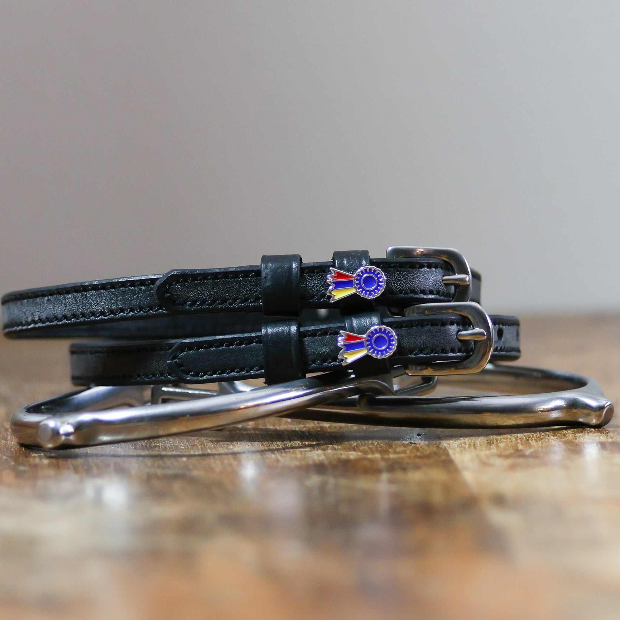 ManeJane Tri-Color Ribbon Spur Strap Spur Straps — black leather, non-stretch, hero image for English riders.