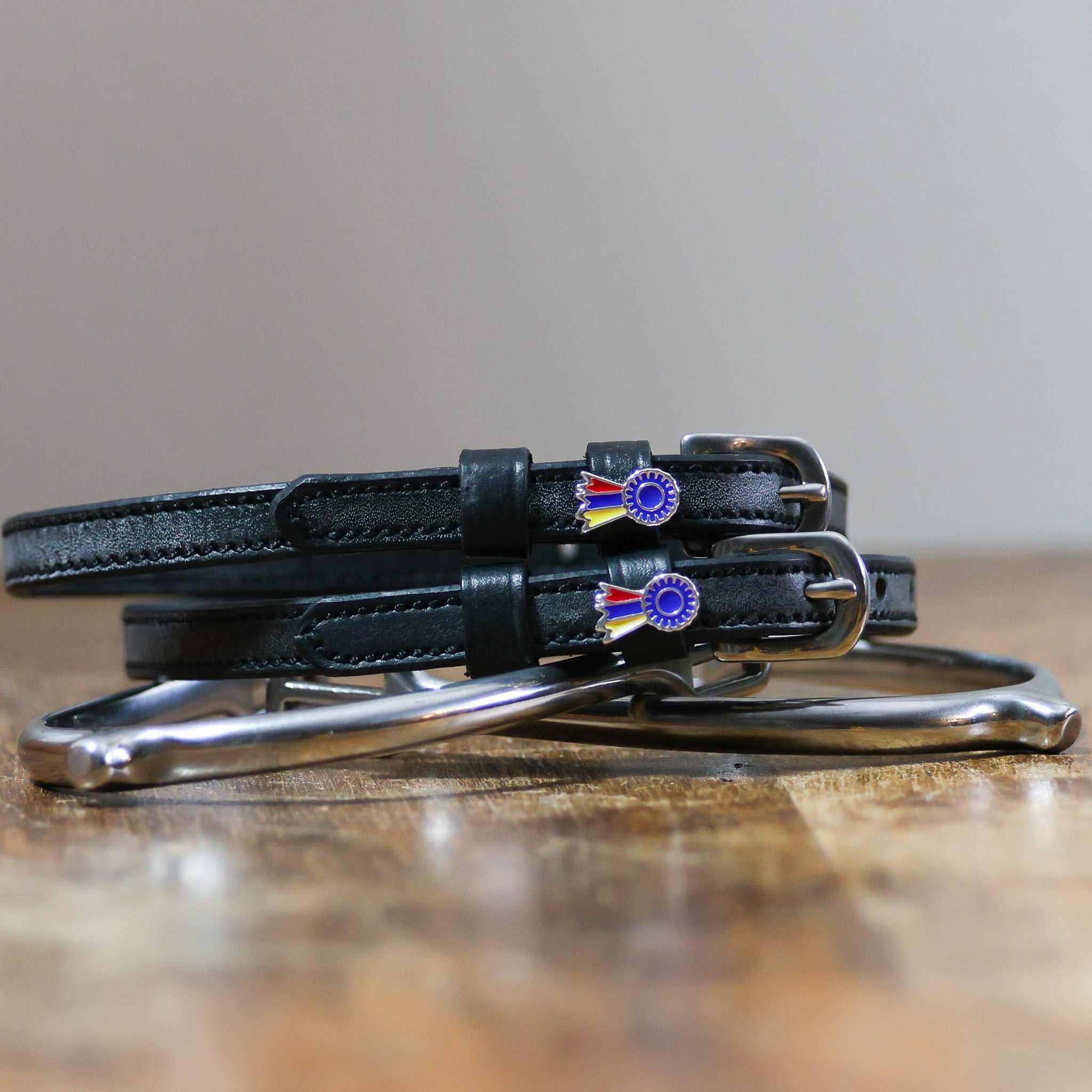 ManeJane Tri-Color Ribbon Spur Strap Spur Straps — black leather, non-stretch, hero image for English riders.