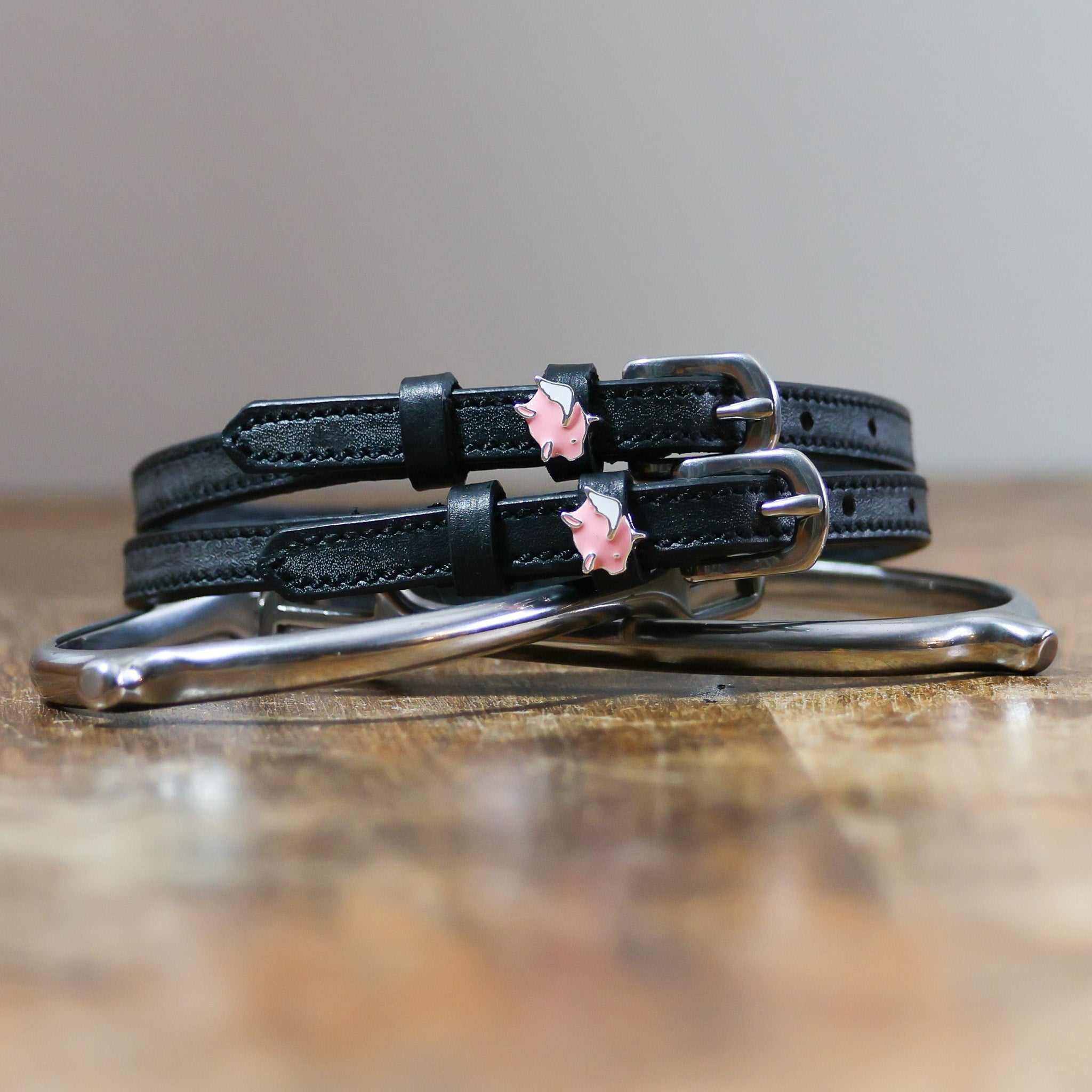 ManeJane Pigs Fly Spur Straps Spur Straps — black leather, non-stretch, hero image for English riders.