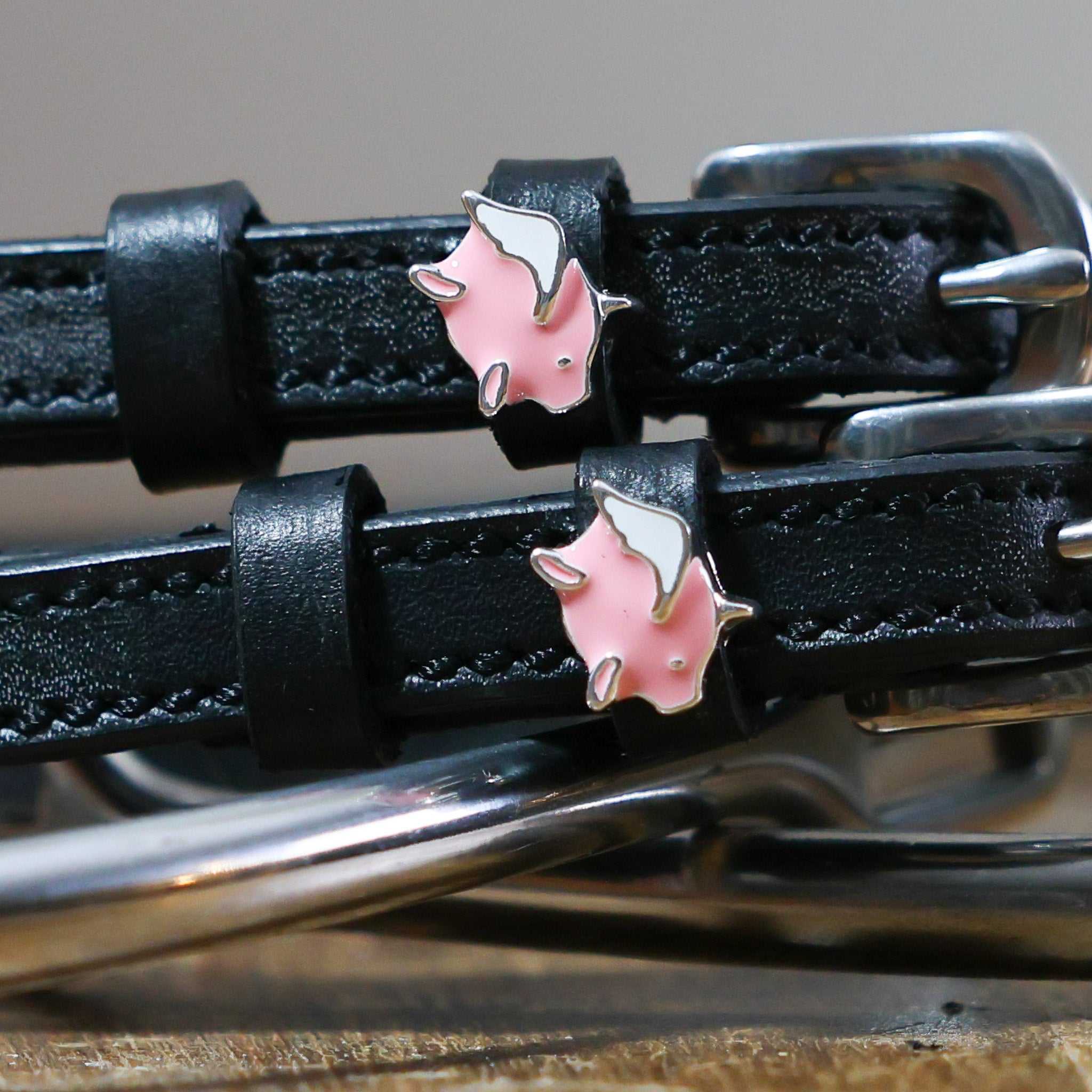 Black leather Pigs Fly Spur Straps with flying pig charm and stainless steel buckles