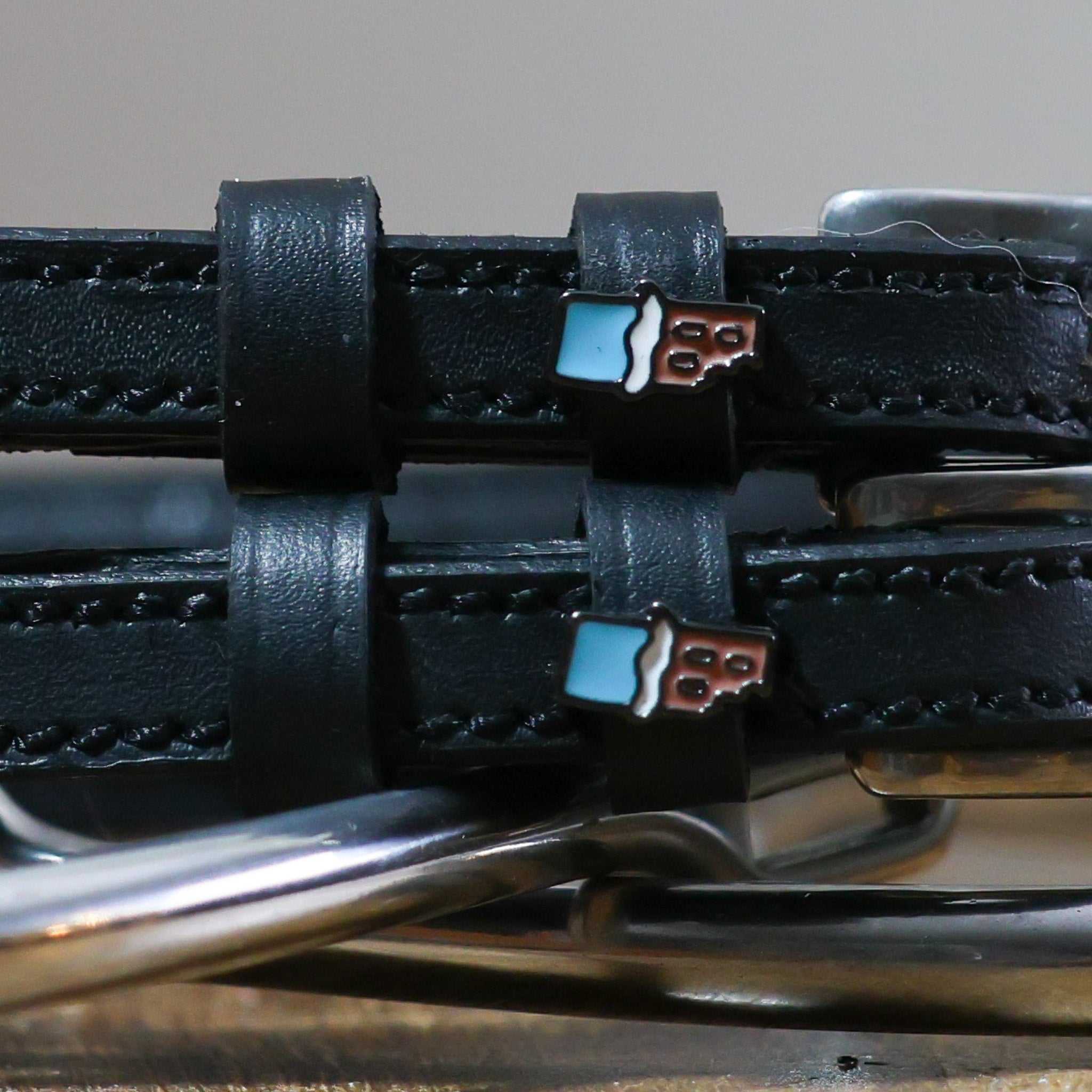 Chocolate Bar Spur Straps in black leather with stainless steel buckle and custom chocolate bar charm