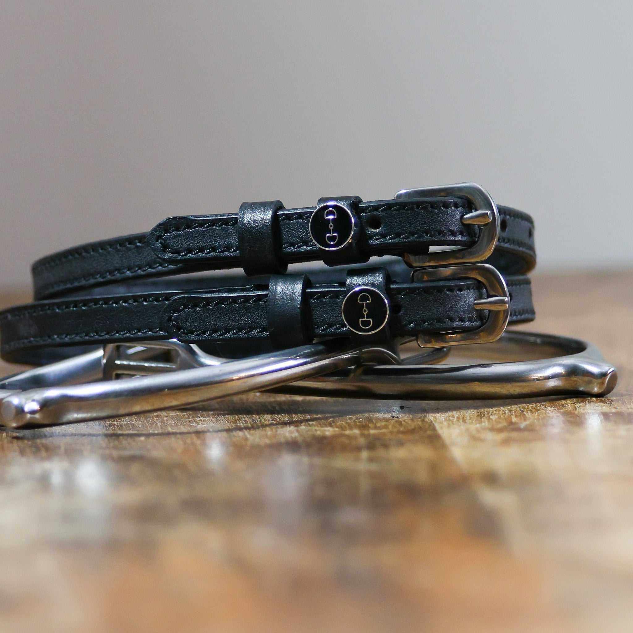 ManeJane D-Ring Spur Straps Spur Straps — black leather, non-stretch, hero image for English riders.