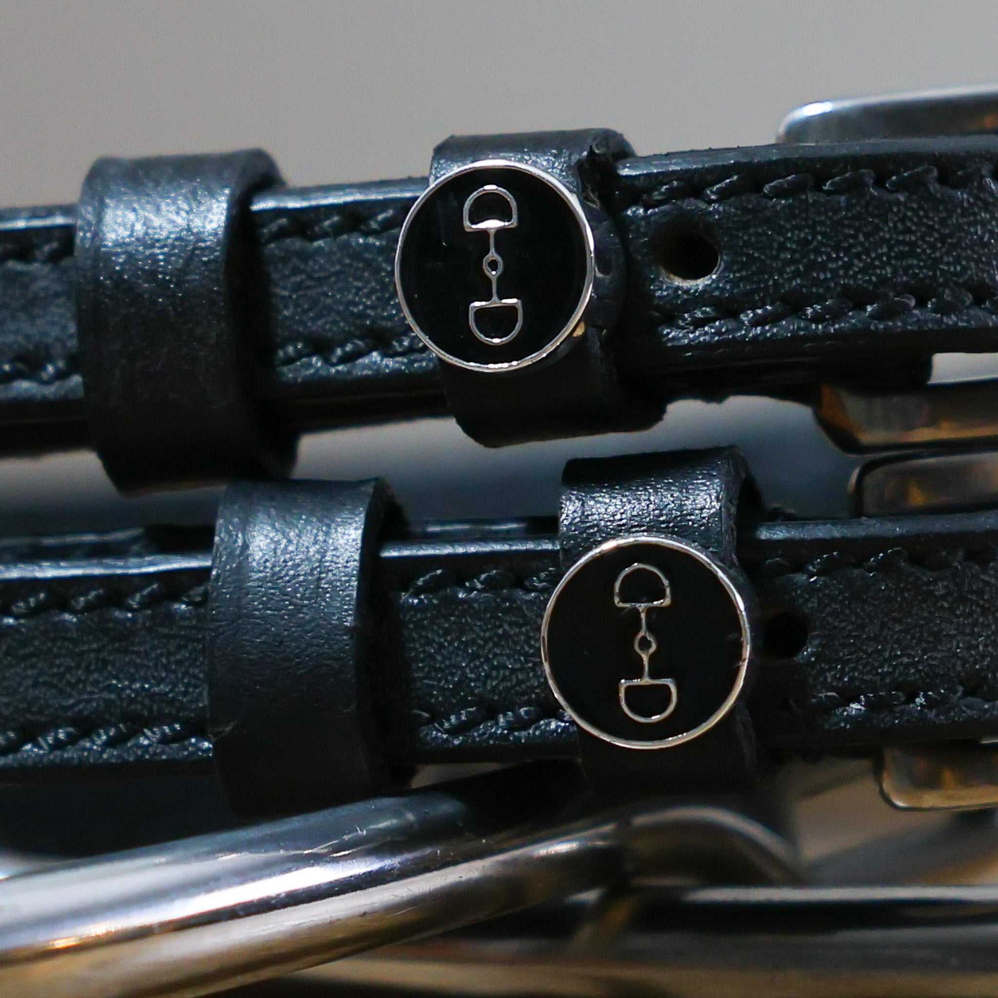 Black leather D-Ring Spur Straps with stainless steel buckle and custom ManeJane charm