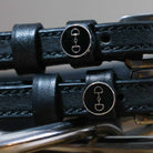 Black leather D-Ring Spur Straps with stainless steel buckle and custom ManeJane charm