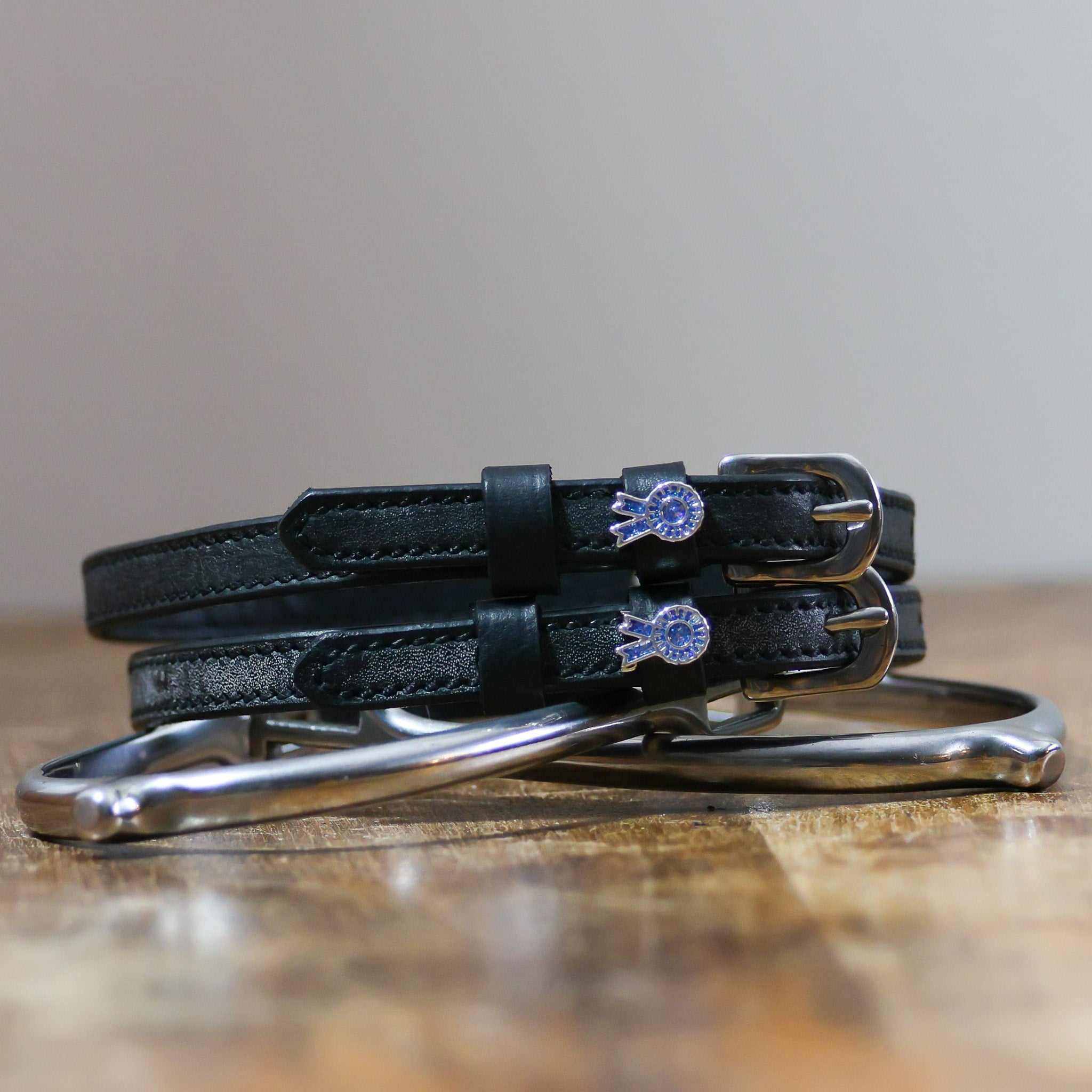 ManeJane Blue Ribbon Spur Straps Spur Straps — black leather, non-stretch, hero image for English riders.