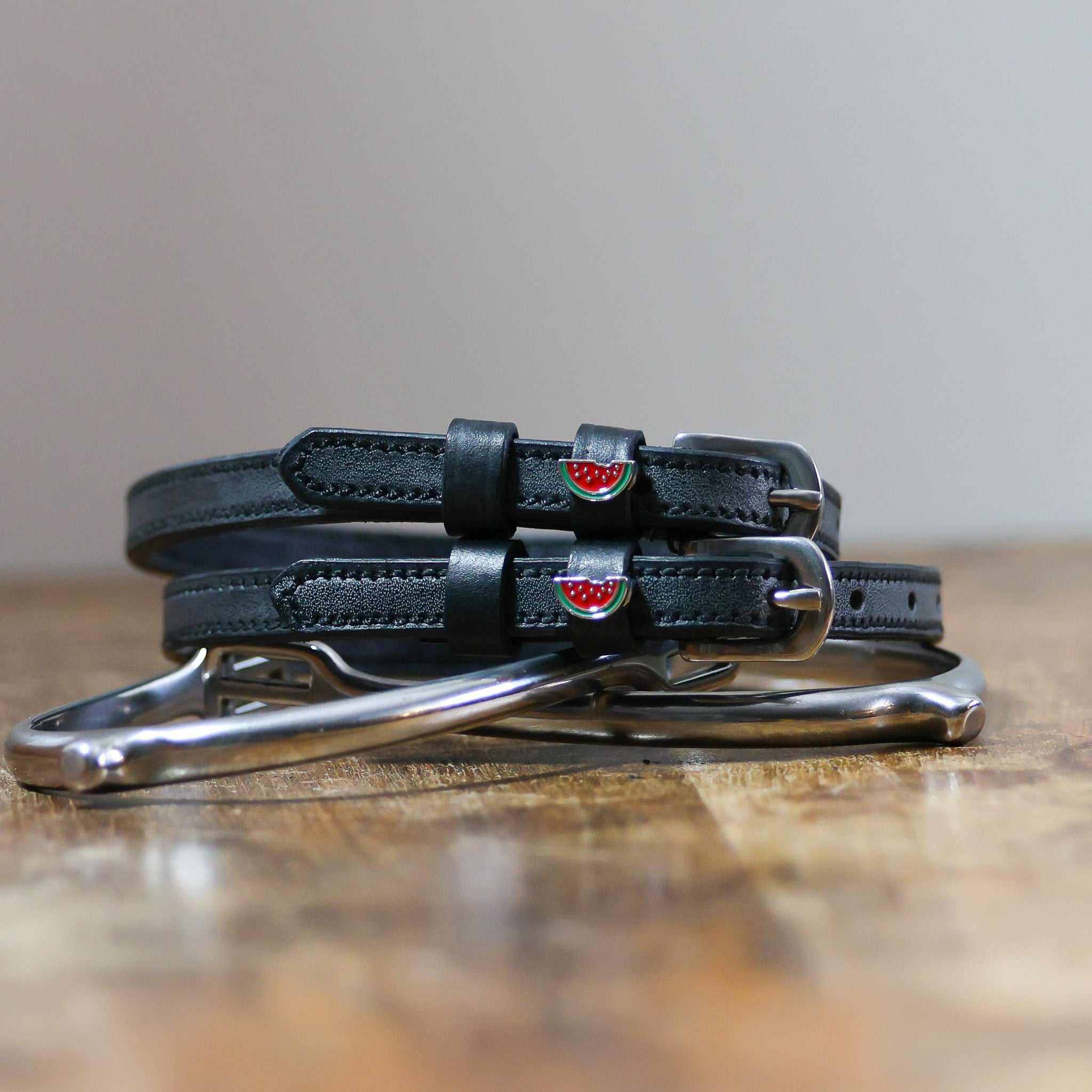 ManeJane Watermelon Spur Straps Spur Straps — black leather, non-stretch, hero image for English riders.