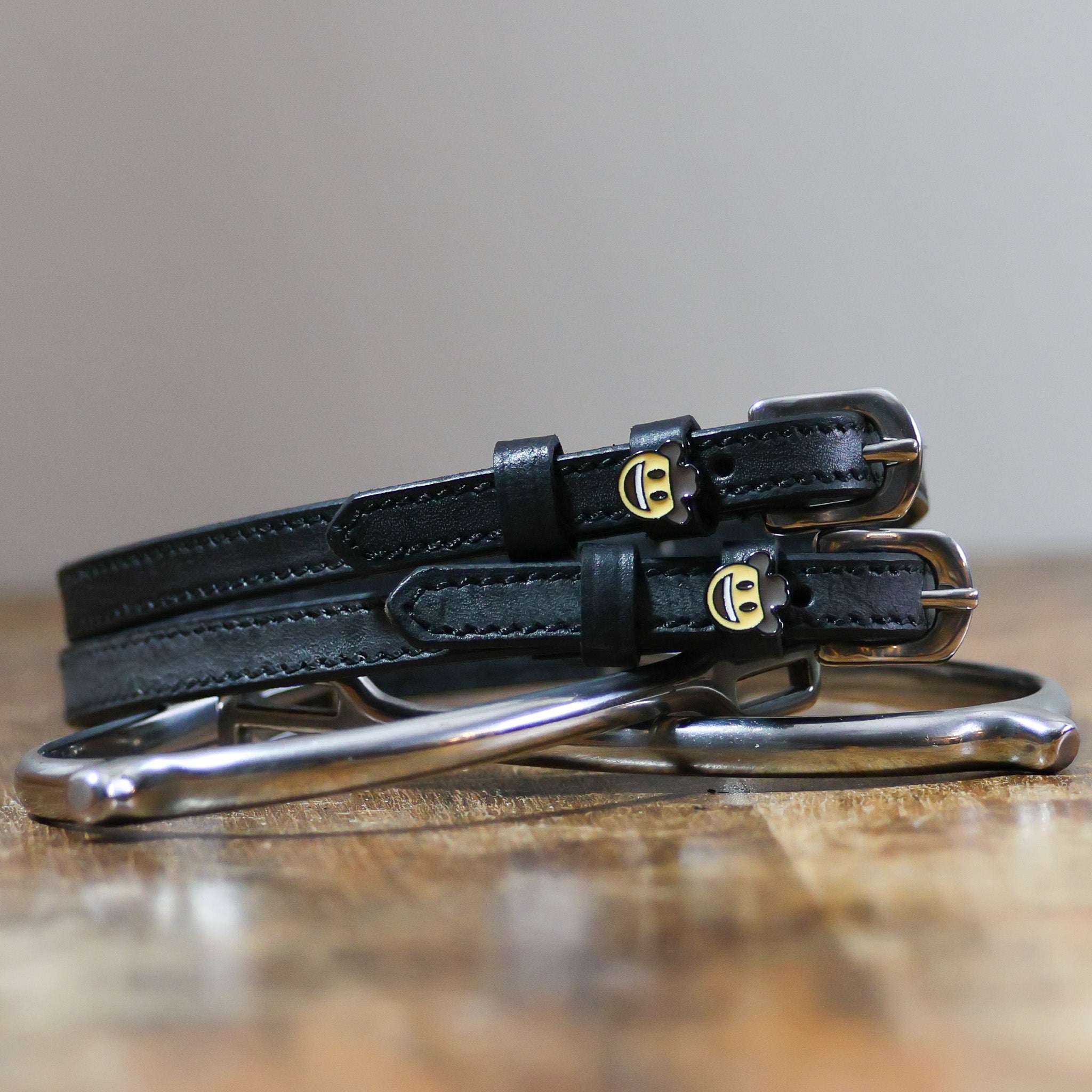 ManeJane Cowboy Emoji Spur Strap Spur Straps — black leather, non-stretch, hero image for English riders.
