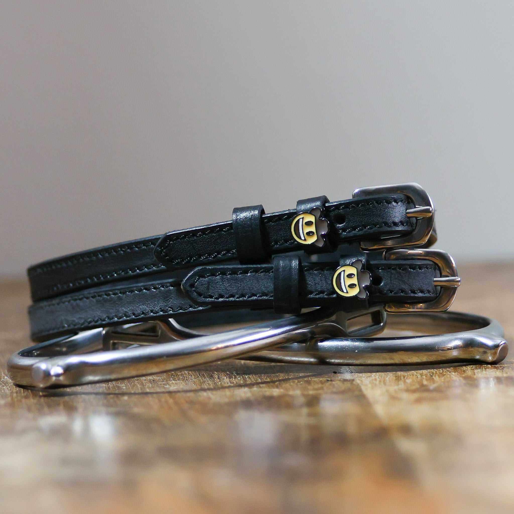 ManeJane Cowboy Emoji Spur Strap Spur Straps — black leather, non-stretch, hero image for English riders.