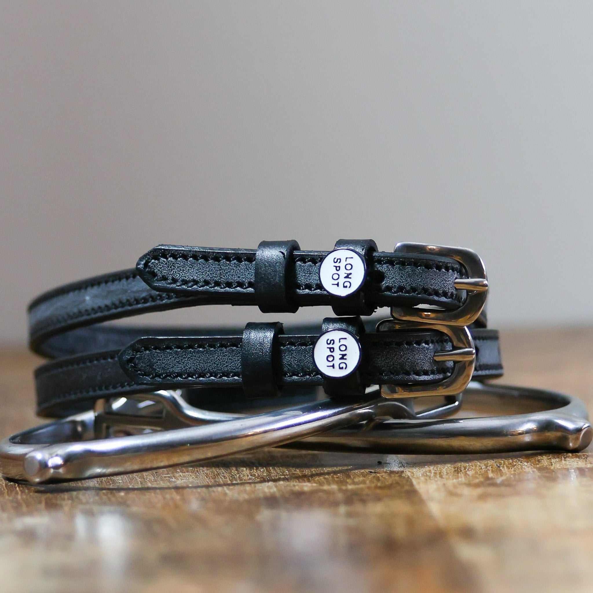 ManeJane Long Spot Spur Straps Spur Straps — black leather, non-stretch, hero image for English riders.