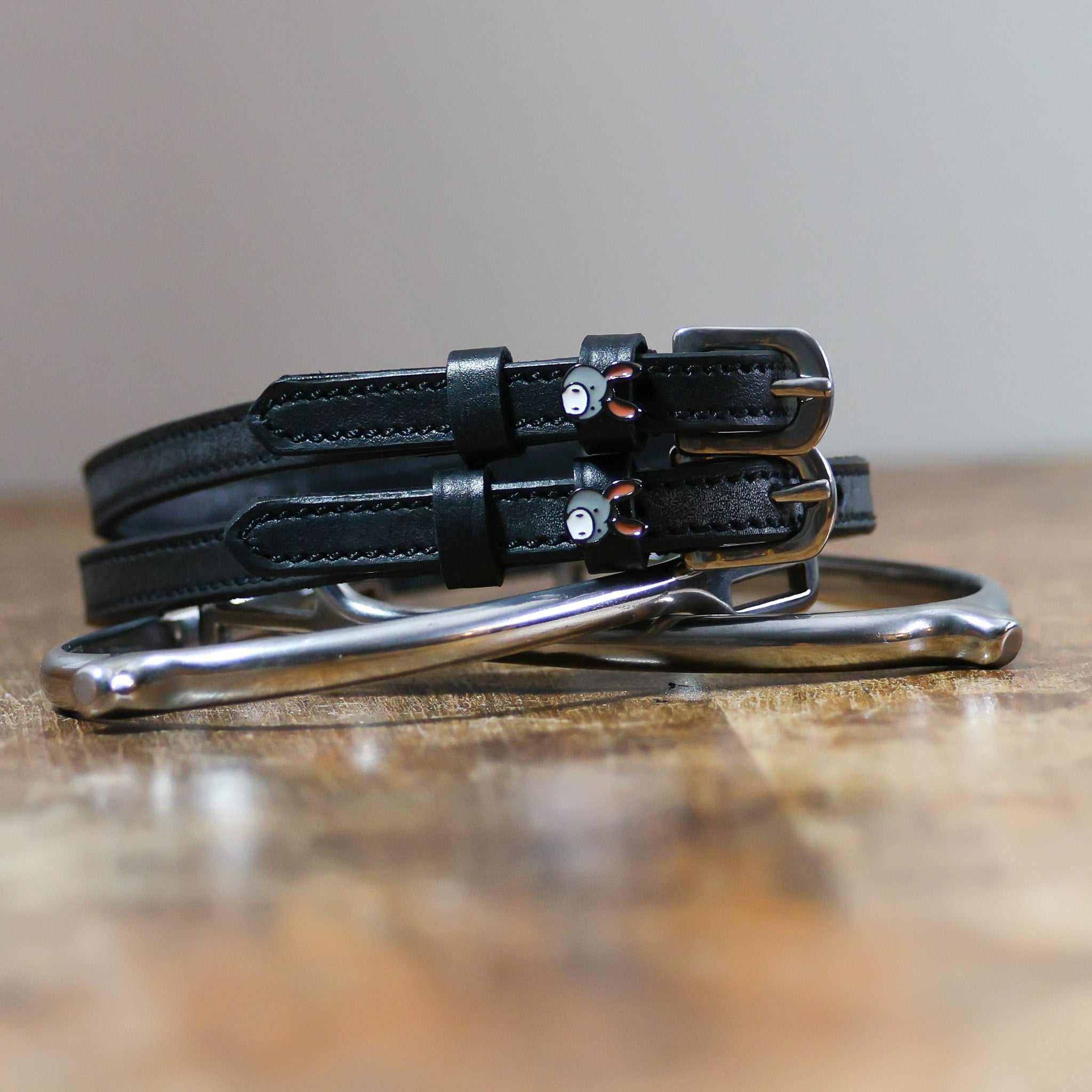 ManeJane Donkey Spur Strap Spur Straps — black leather, non-stretch, hero image for English riders.