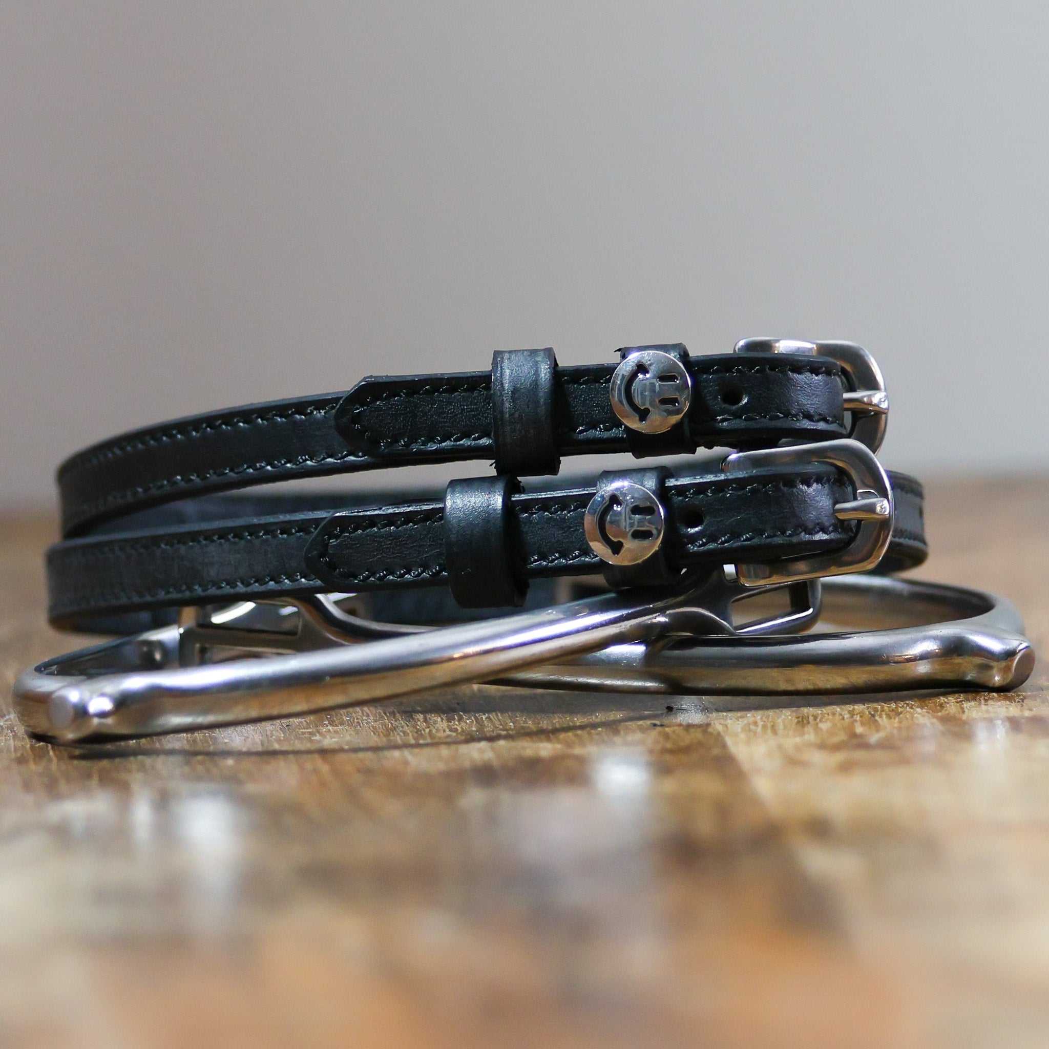 ManeJane Happy Face Spur Straps Spur Straps — black leather, non-stretch, hero image for English riders.