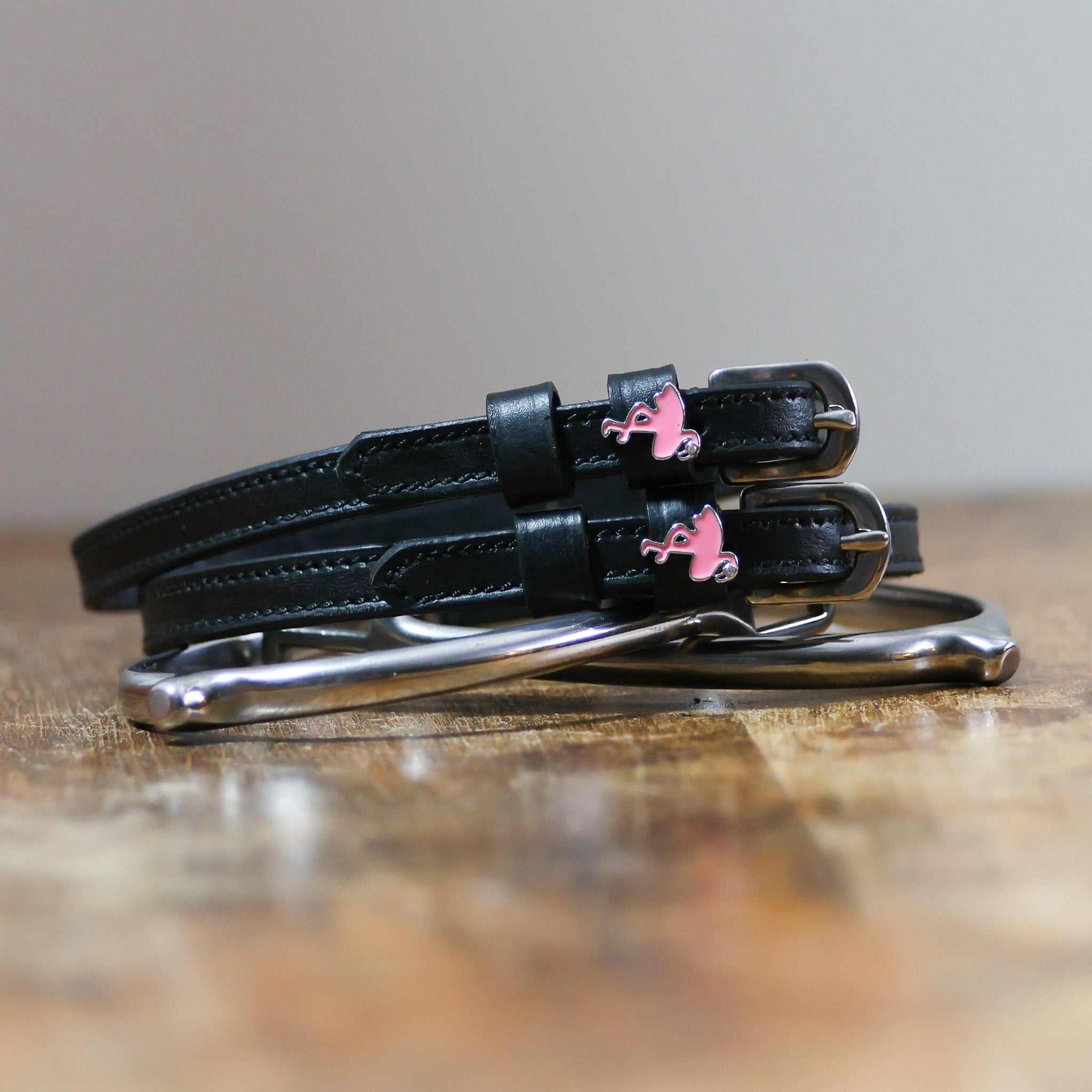 ManeJane Flamingo Spur Straps Spur Straps — black leather, non-stretch, hero image for English riders.