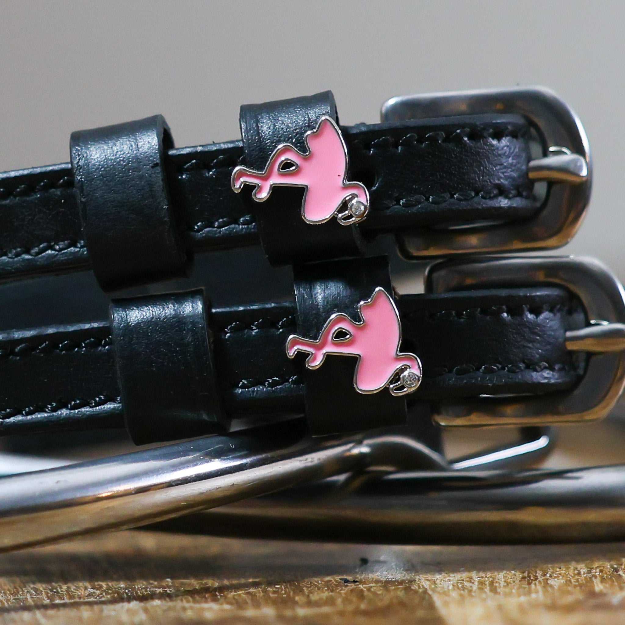 Black leather Flamingo Spur Straps with stainless steel buckles and pink flamingo charms