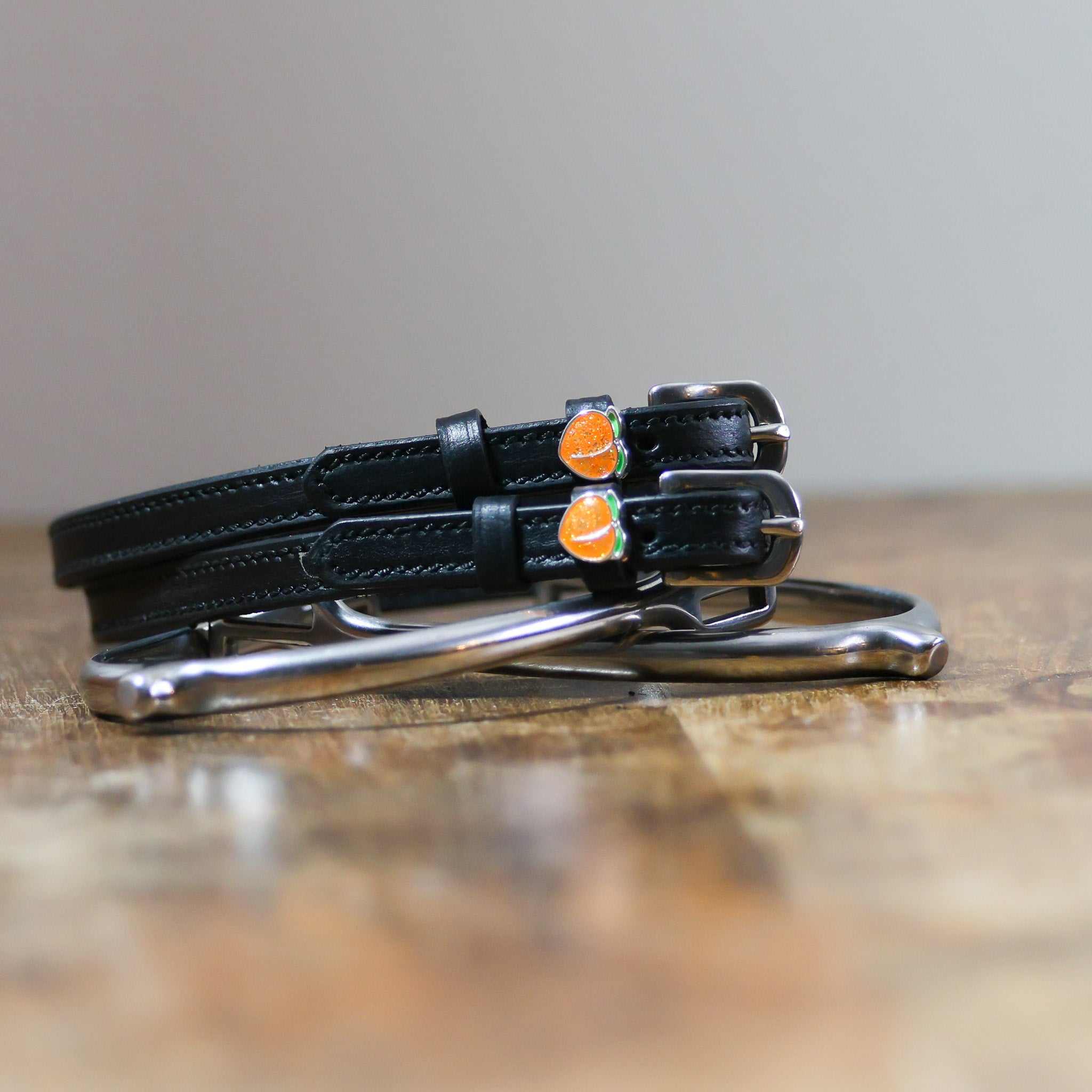 ManeJane Peach Spur Straps Spur Straps — black leather, non-stretch, hero image for English riders.