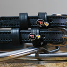 F Bomb Spur Straps black leather with stainless steel buckle and custom charm close-up