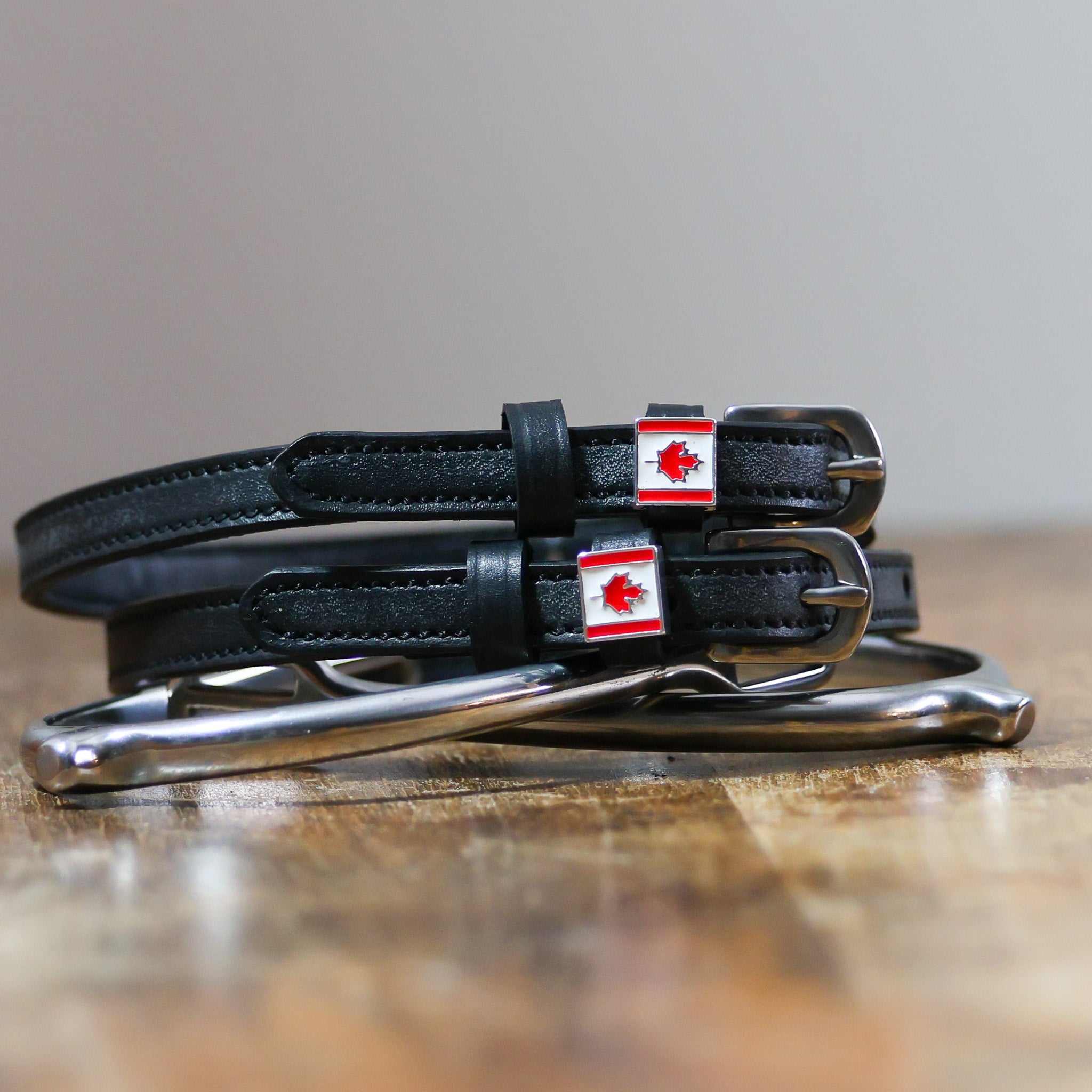 ManeJane Canadian Flag Spur Straps Spur Straps — black leather, non-stretch, hero image for English riders.