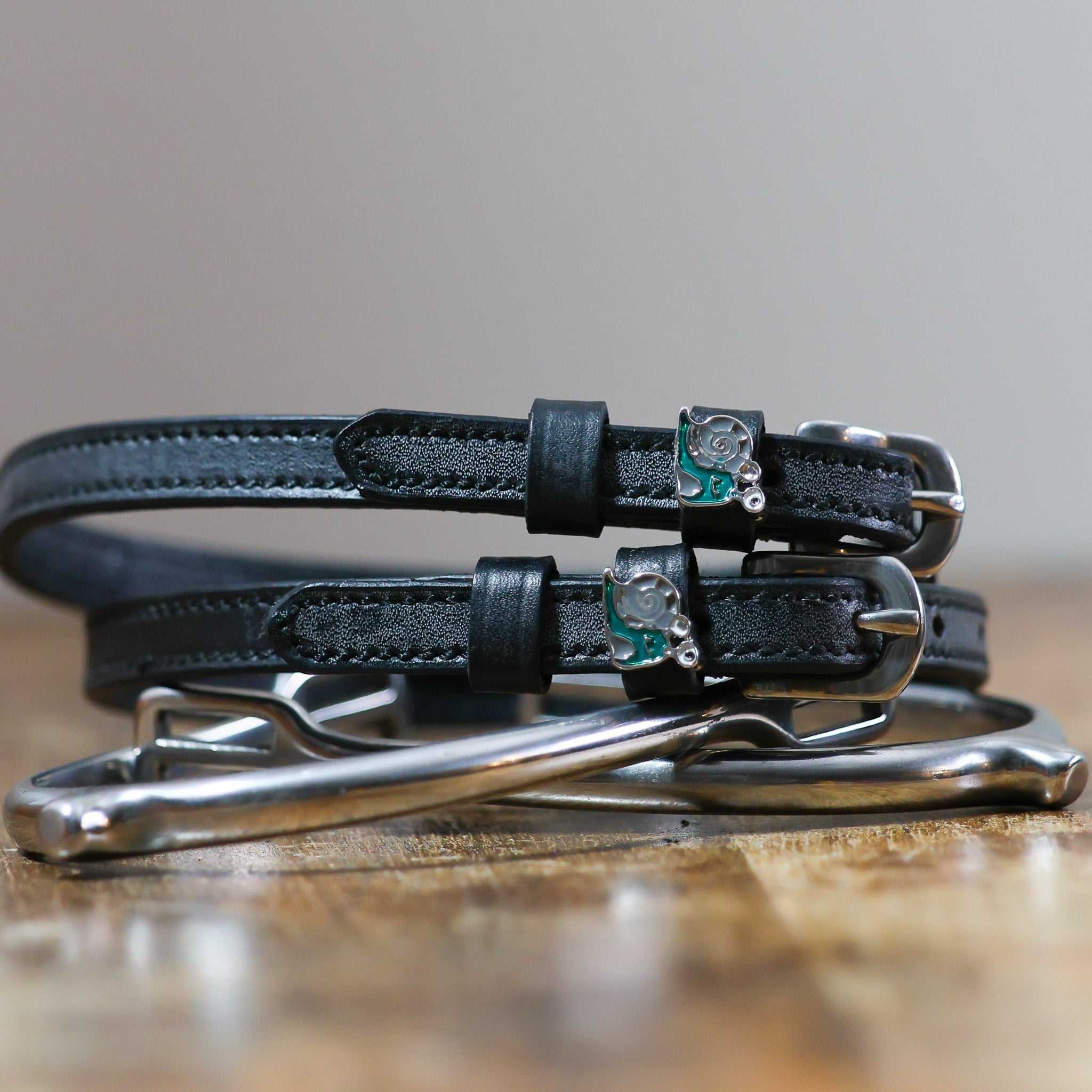 ManeJane Snail Spur Straps Spur Straps — black leather, non-stretch, hero image for English riders.