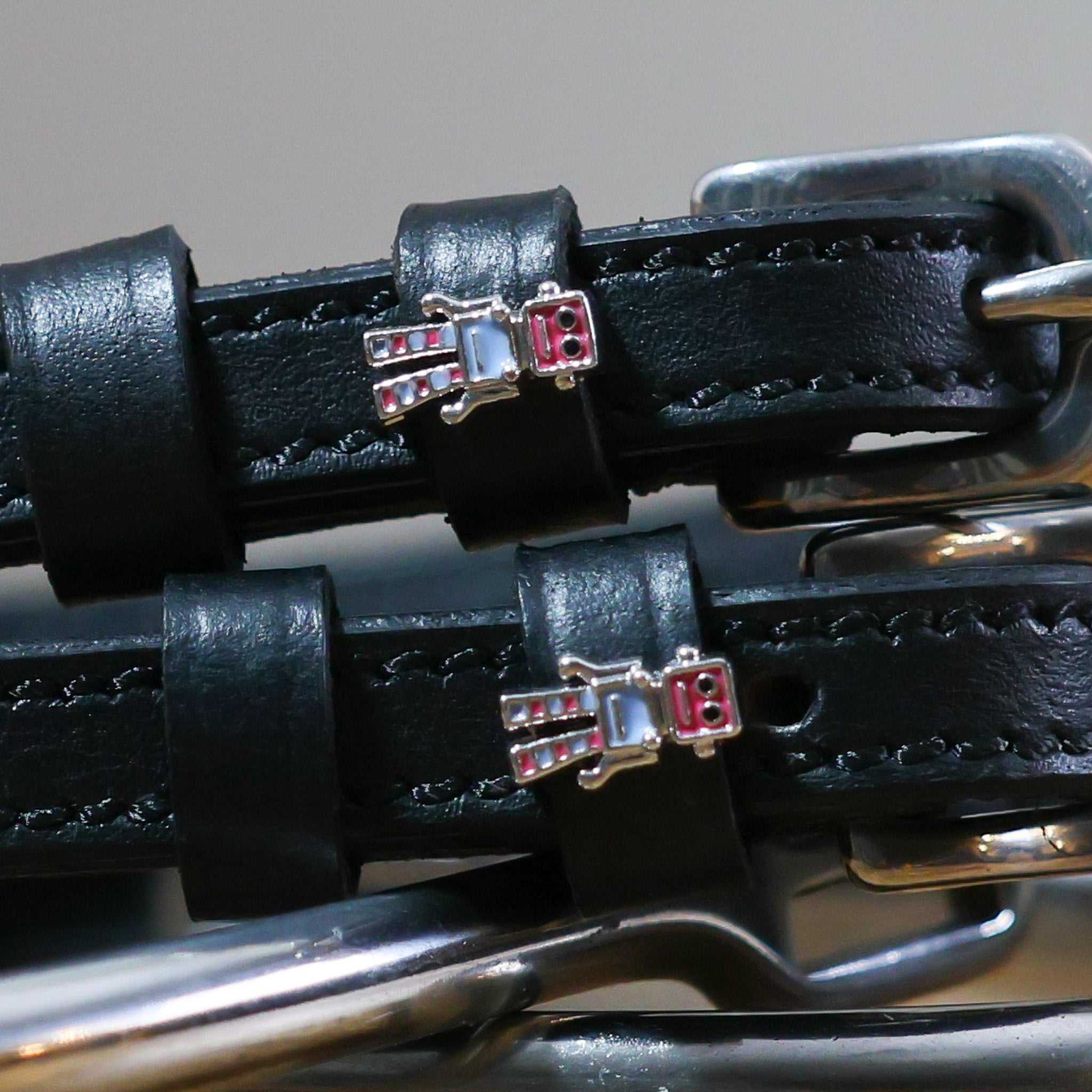 Close-up of black leather Robot Spur Straps with robot charm and stainless steel buckle