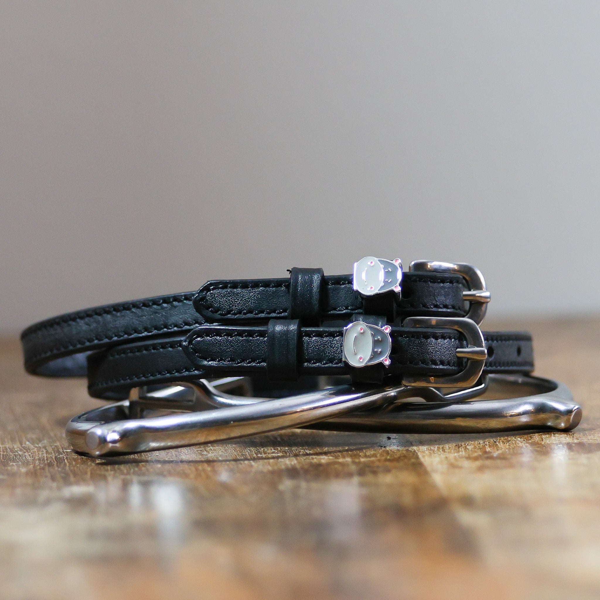 ManeJane Hippo Face Spur Straps Spur Straps — black leather, non-stretch, hero image for English riders.
