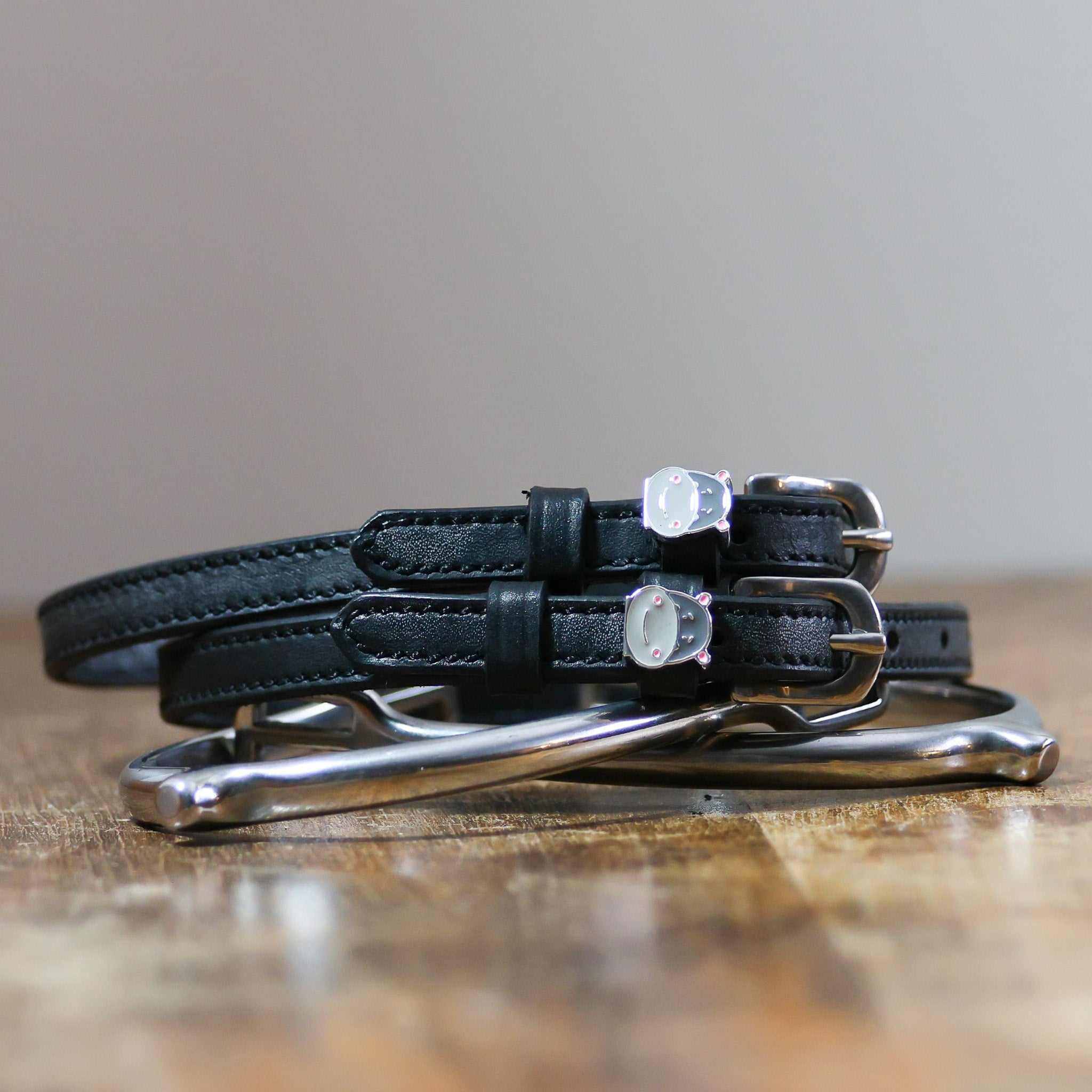 ManeJane Hippo Face Spur Straps Spur Straps — black leather, non-stretch, hero image for English riders.