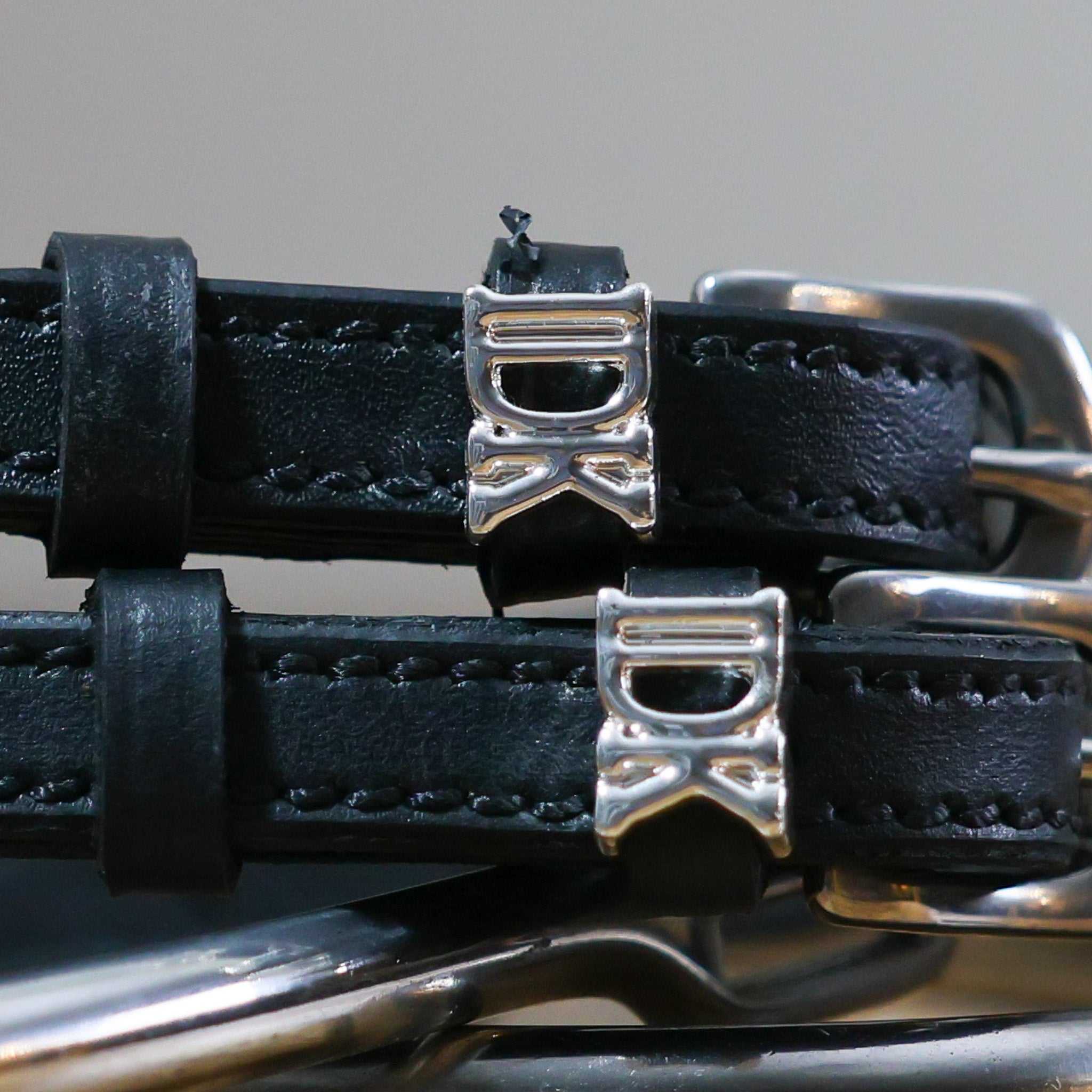 Black leather spur straps with stainless steel buckles and custom "I Don't Know" silver charms