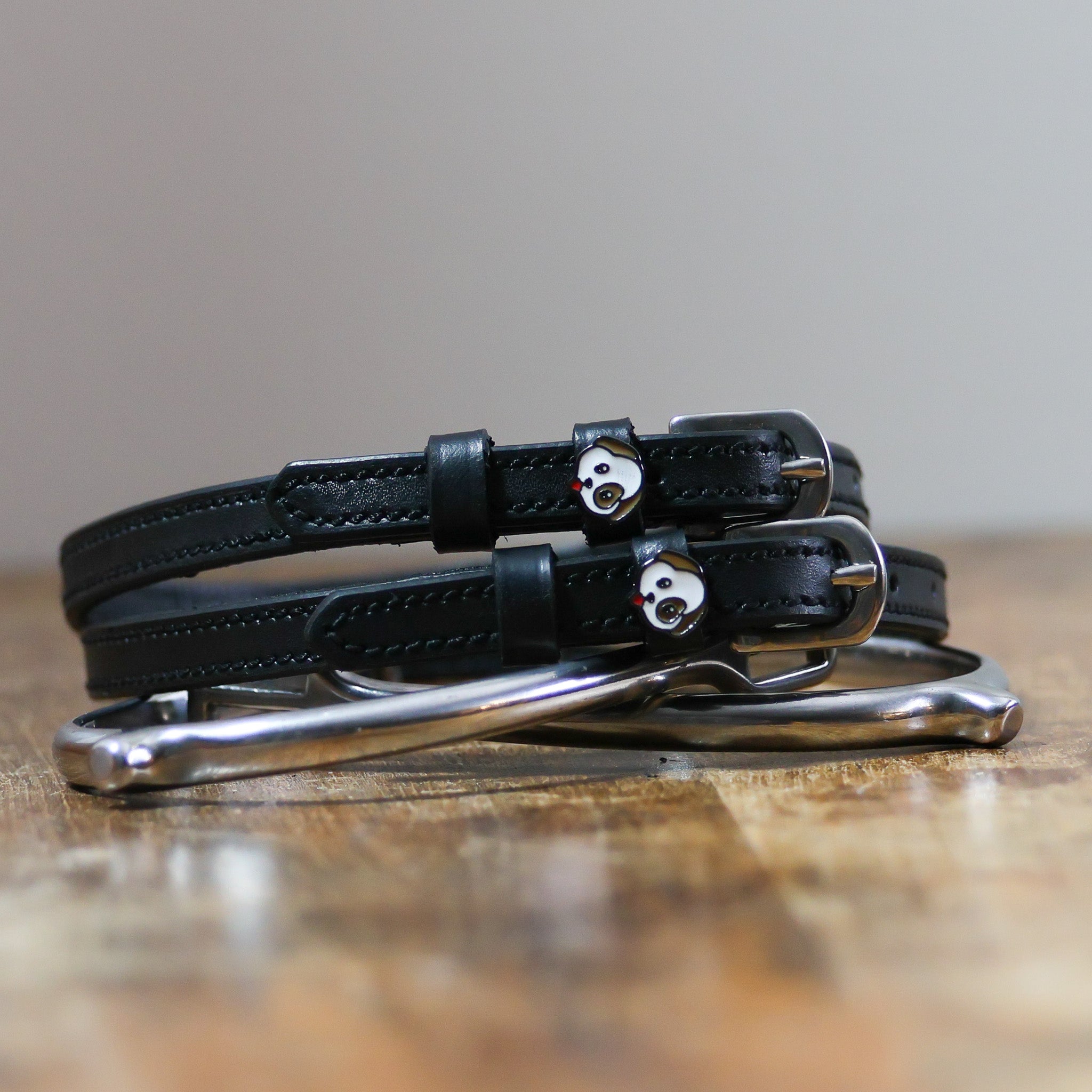 ManeJane Dog - Puppy Spur Straps Spur Straps — black leather, non-stretch, hero image for English riders.