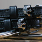 Black leather Queenie Spur Straps with stainless steel crown buckle and custom charm