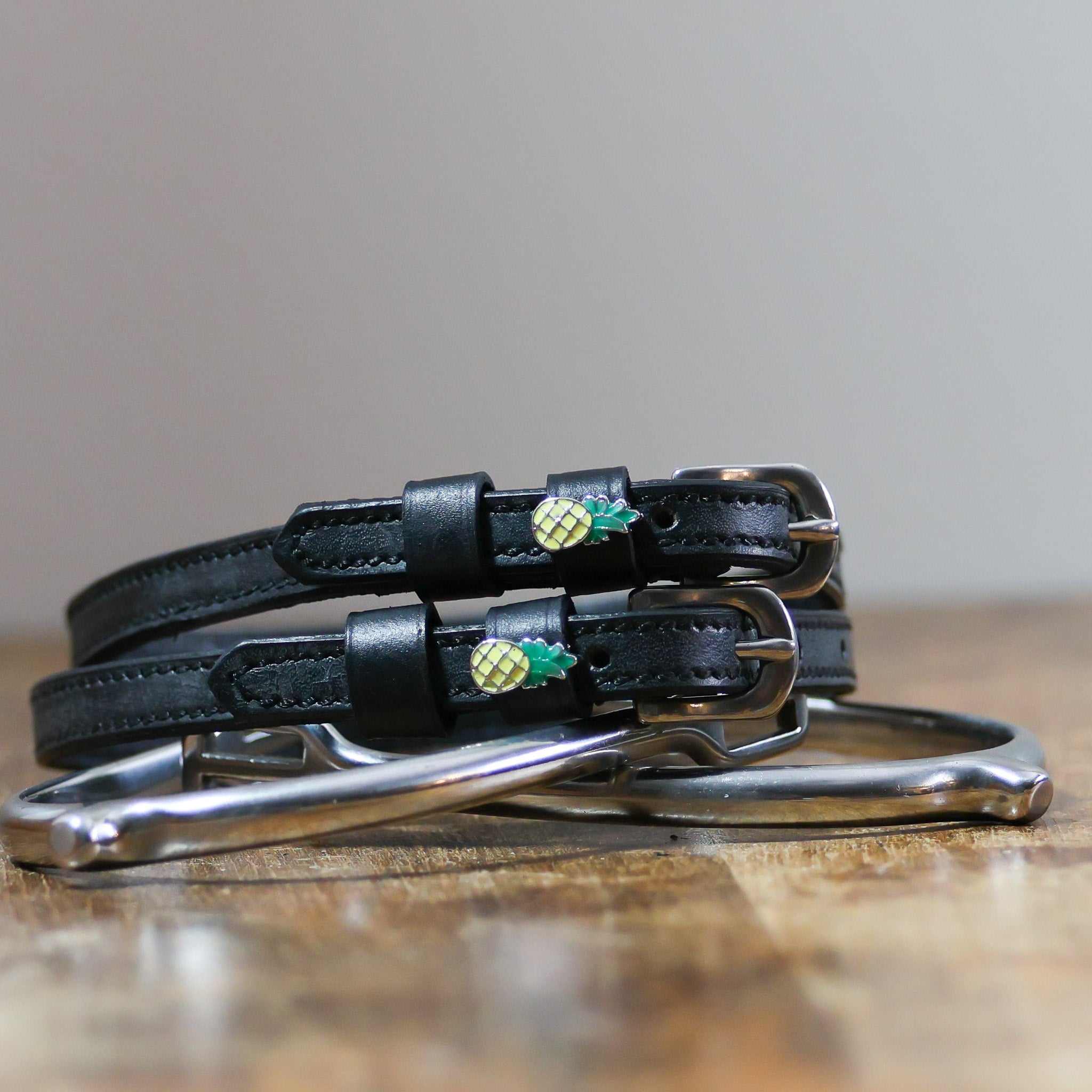 ManeJane Pineapple Spur Straps Spur Straps — black leather, non-stretch, hero image for English riders.