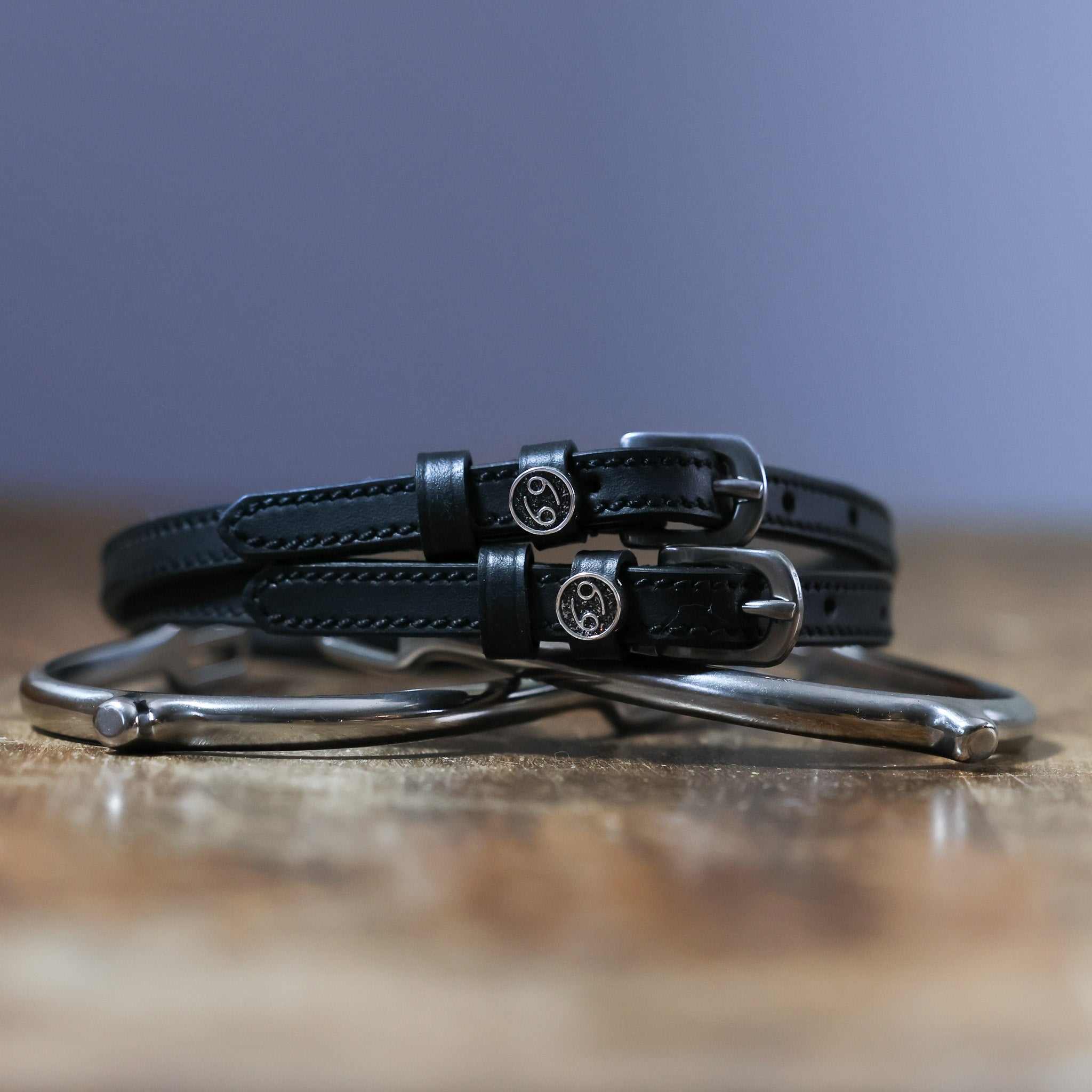 Black leather Cancer Spur Straps with stainless steel buckles and custom charms on spurs