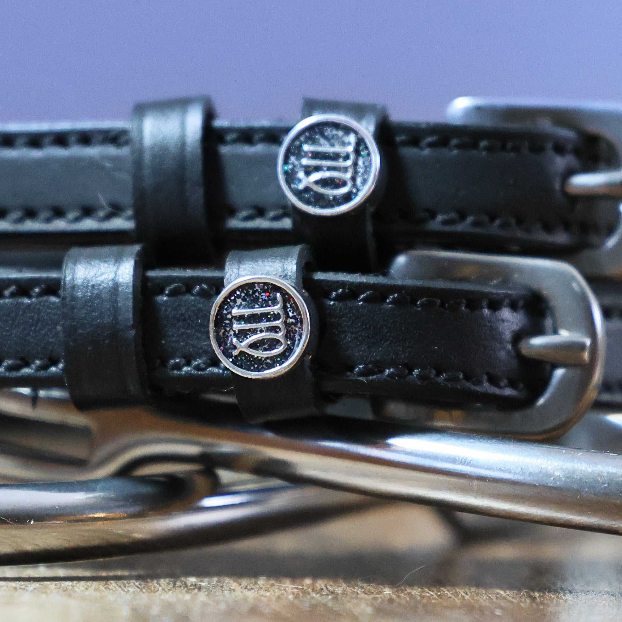 Black leather Virgo Spur Straps with stainless steel buckles and custom zodiac charm