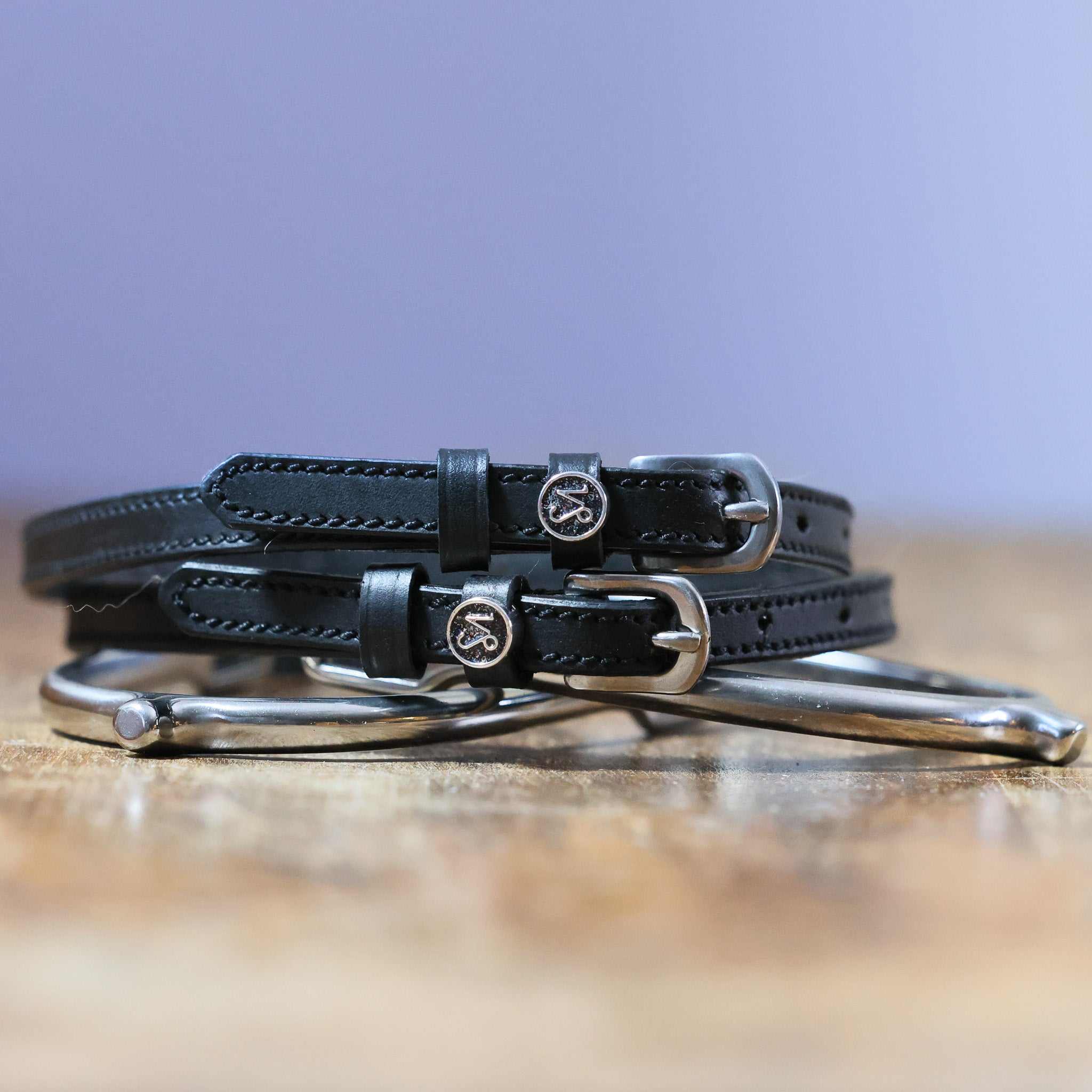 Black leather Capricorn Spur Straps with stainless steel buckle and custom charm by ManeJane