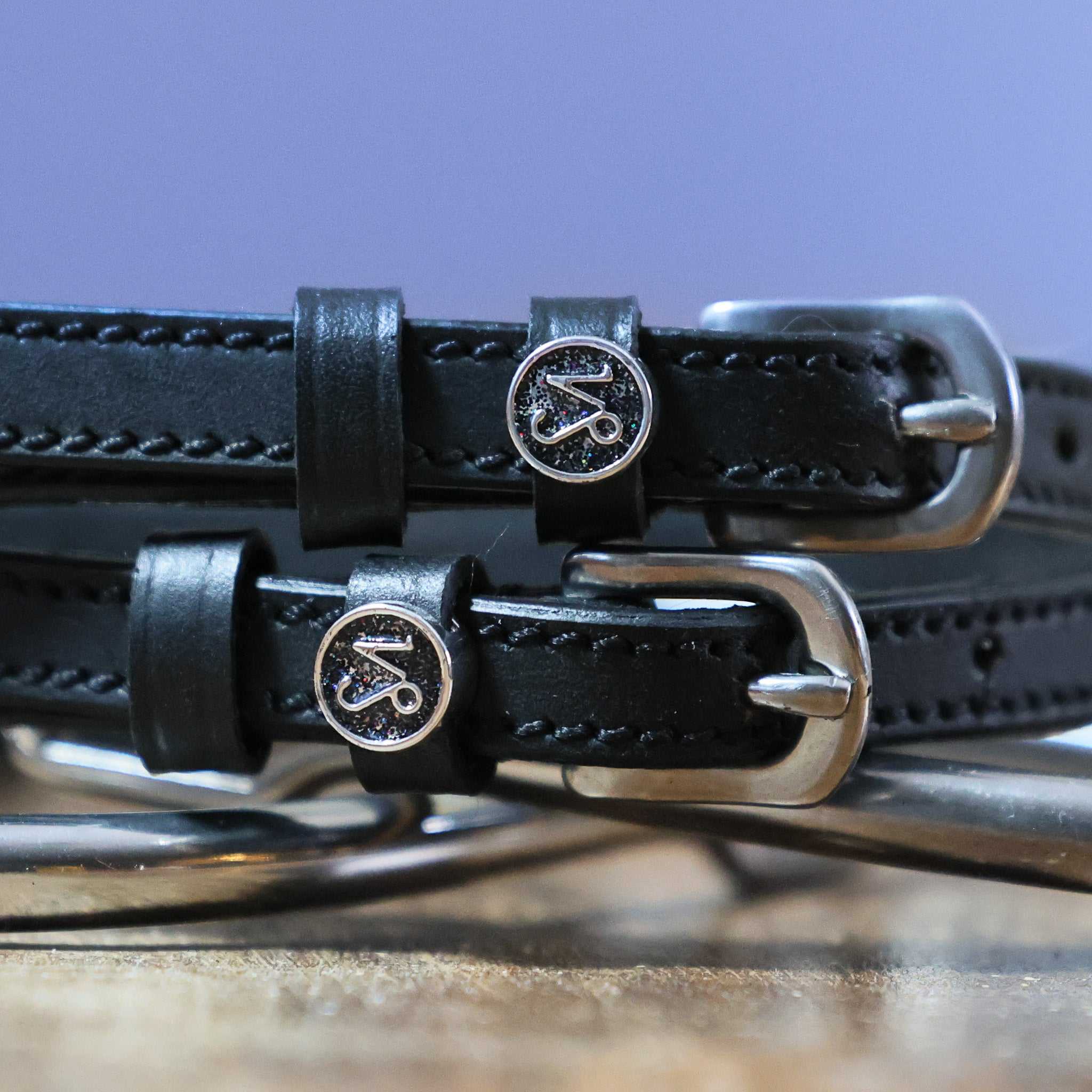 Black leather Capricorn Spur Straps with stainless steel buckles and custom Capricorn charms