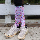 Limited edition colorful boot socks with unique prints worn with sneakers outdoors