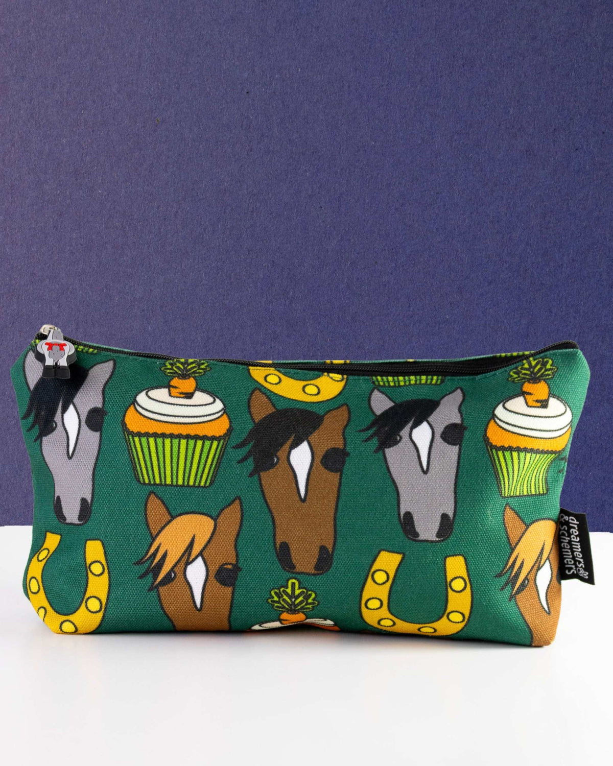 Carrot Cake zip pouch in deep green, printed with pony faces, horseshoes and carrot cupcakes, by Dreamers & Schemers