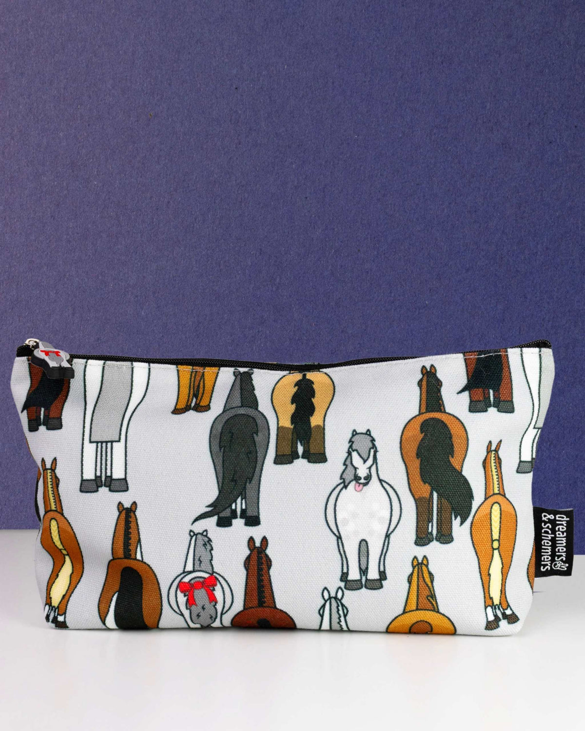 Butts zip pouch in white, printed with a line-up of cartoon horse hindquarters, by Dreamers & Schemers