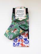 The Naughty List boot socks shown folded with the included spare sock and printed cuff detail