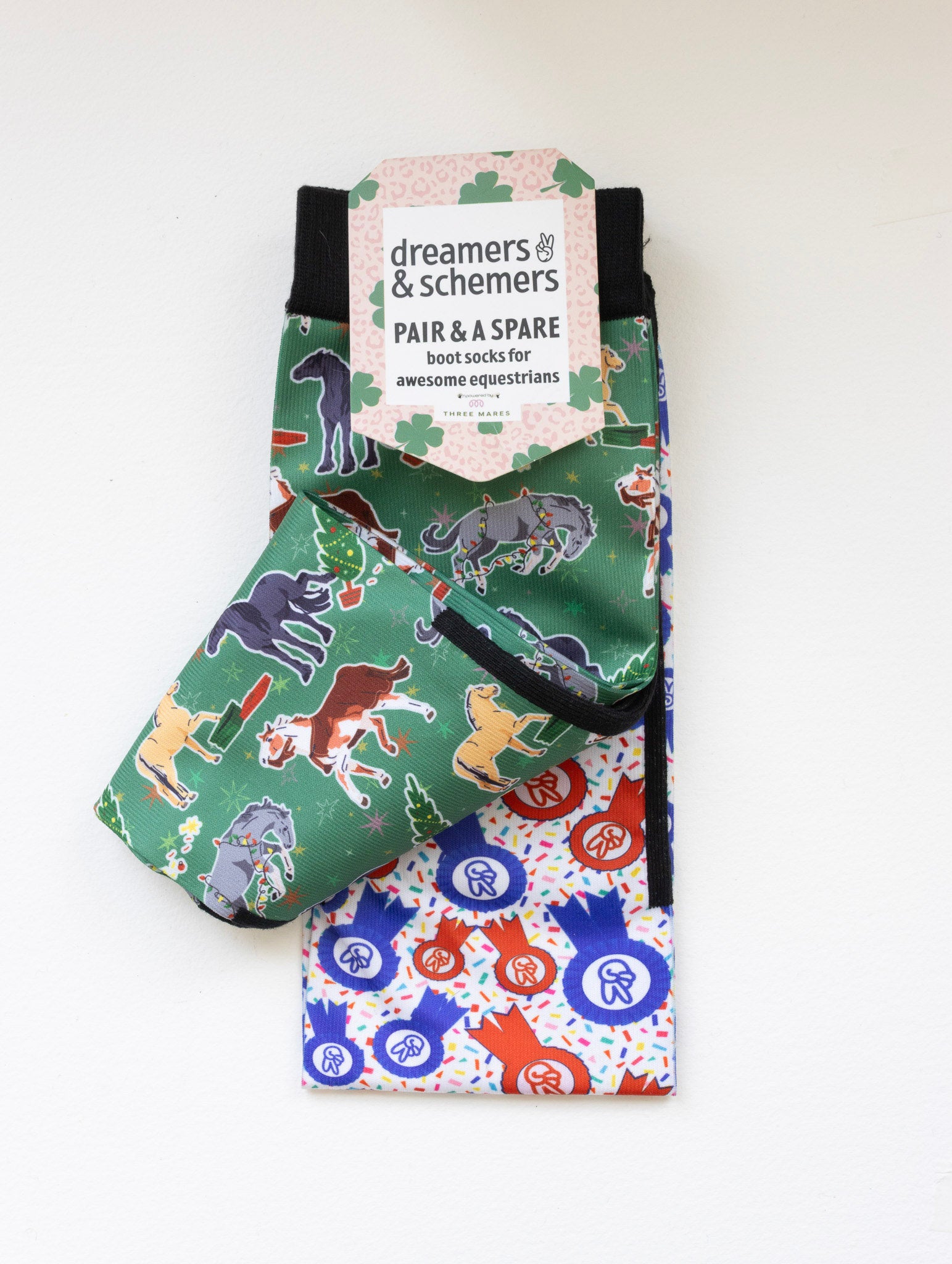 The Naughty List youth boot socks shown folded with the included spare sock and patterned cuff