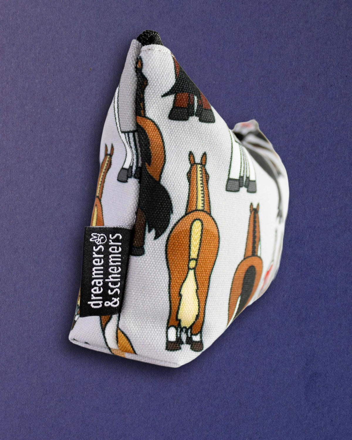 Butts pouch standing on its gusset to show it is self-standing, brand tag on the side panel