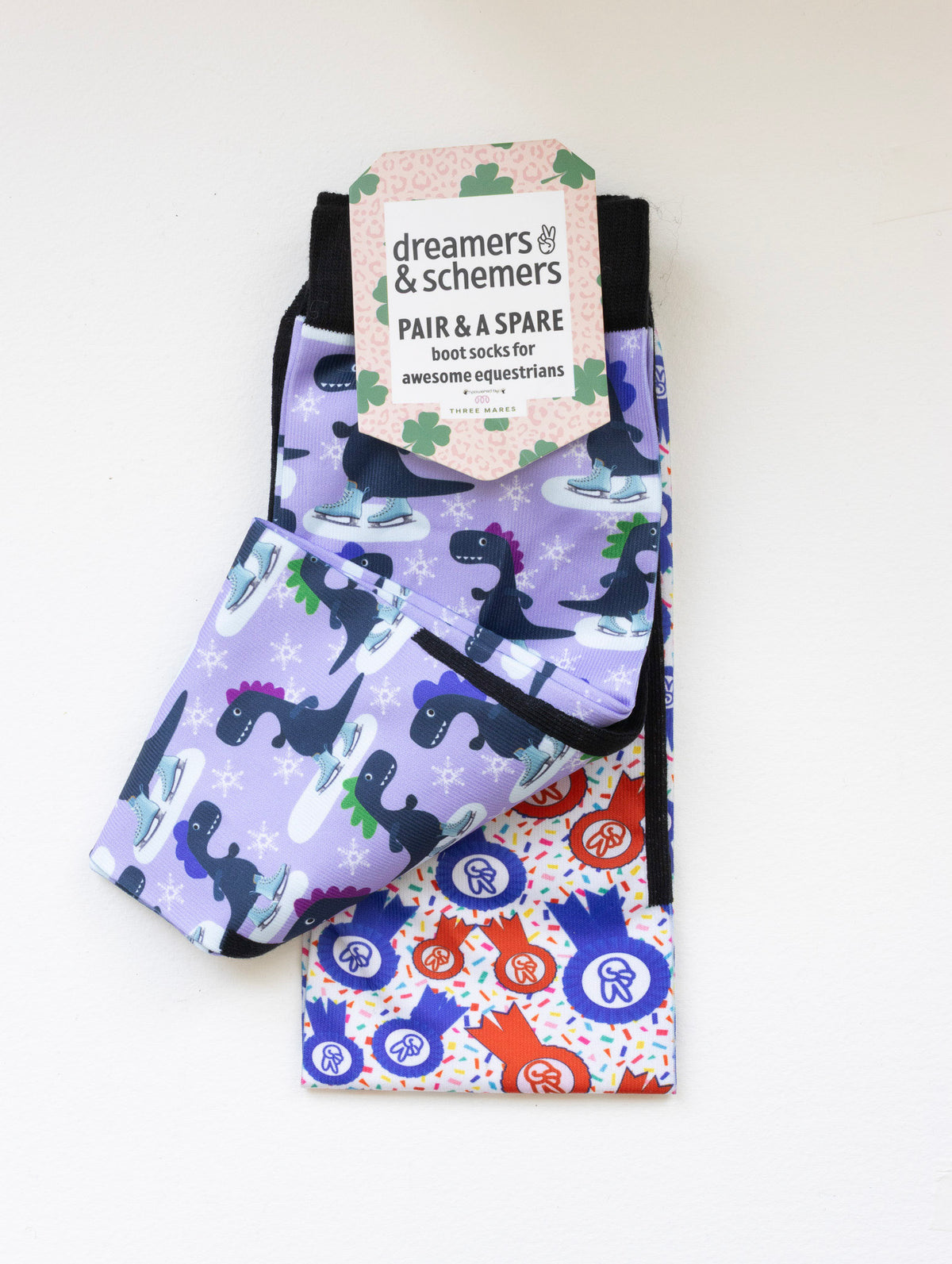 Dino-skate boot socks shown folded with the included spare sock and printed cuff detail