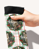 Plaid Tidings custom photo equestrian boot socks, held in hand, close-up of the holly wreath on plaid pattern, by Dreamers & Schemers