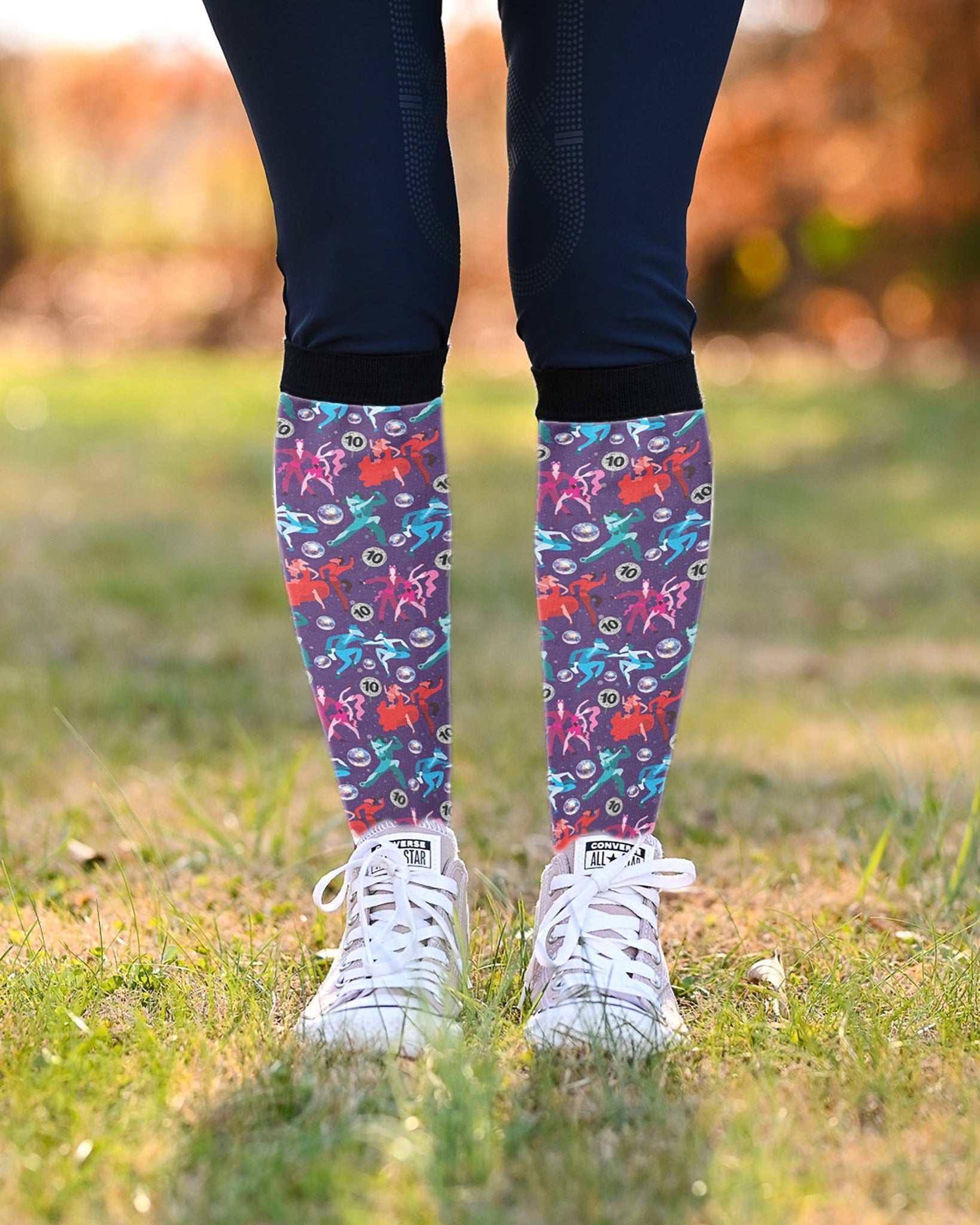 Prancing with the Stars Limited Edition boot socks, dancing couples and disco balls on deep purple, worn over navy breeches with white sneakers, by Dreamers & Schemers