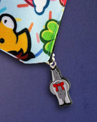 Close-up of the bad pony zip pull charm hanging from the black zip on the Lucky Charm pouch