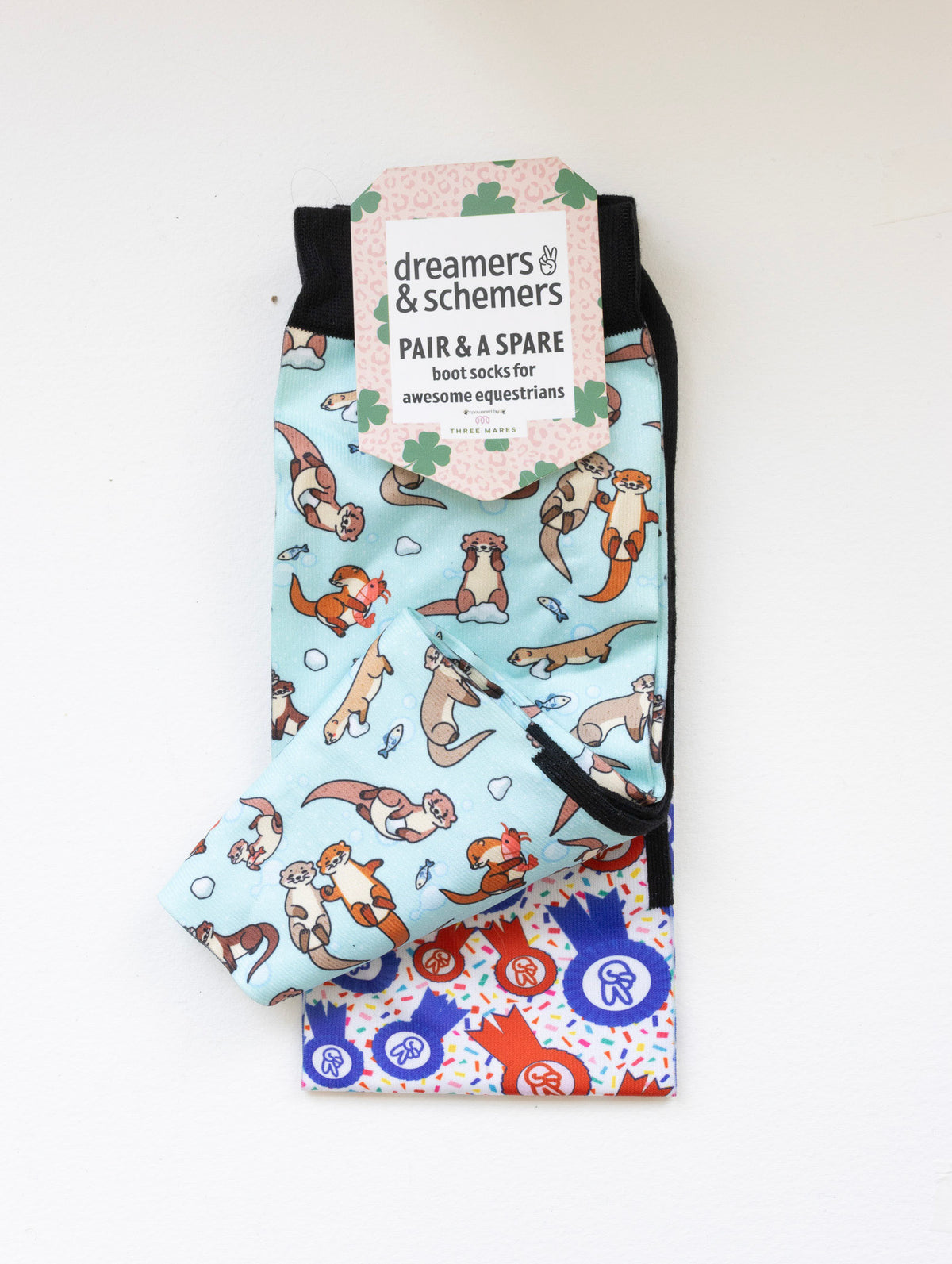 Otter-ly Adorable boot socks shown folded with the included spare sock and printed cuff detail