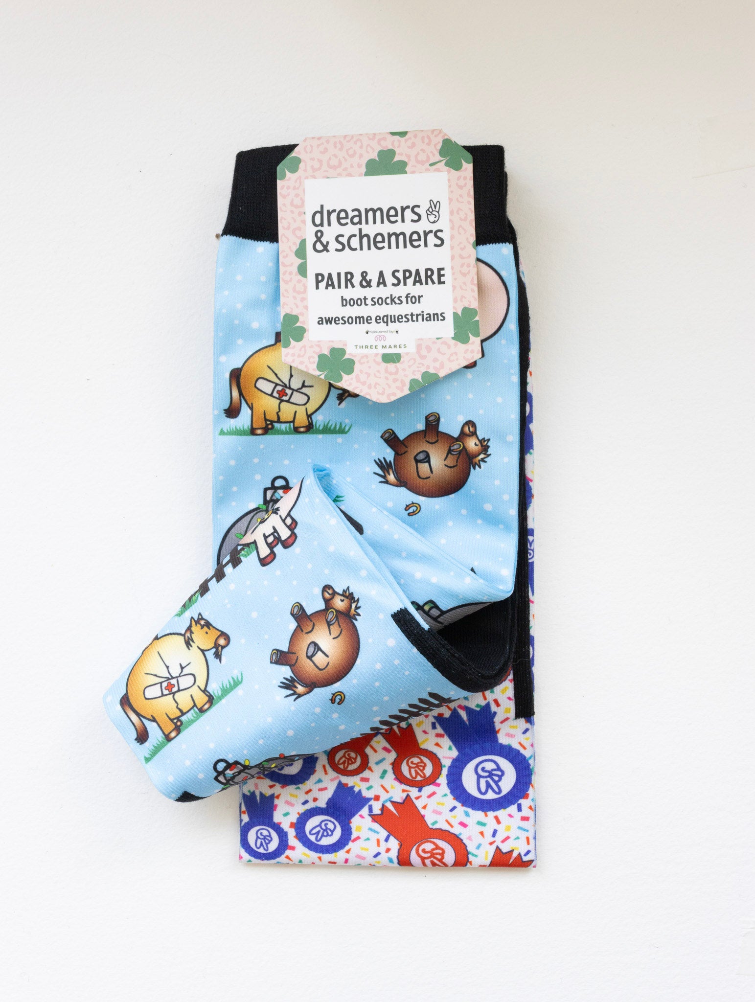 Pasture Ornaments boot socks shown folded with the included spare sock and printed cuff detail