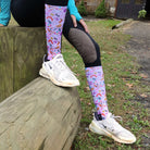 Colorful limited edition boot socks with music and shoe patterns worn outdoors